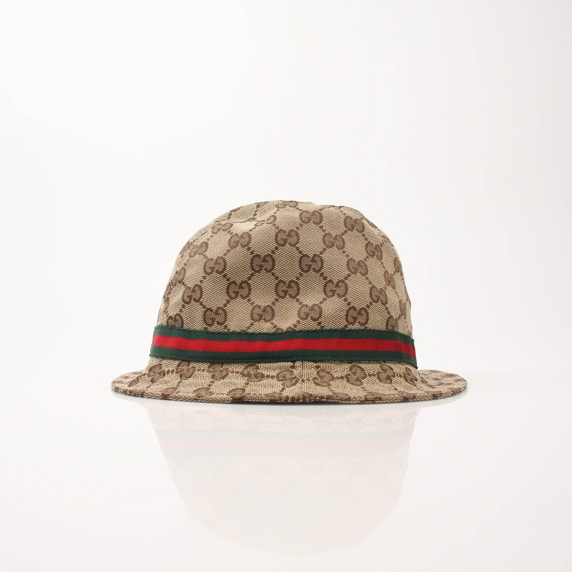 Gucci GG canvas bucket hat in beige with black logo, stylish accessories for sun protection and fashion.