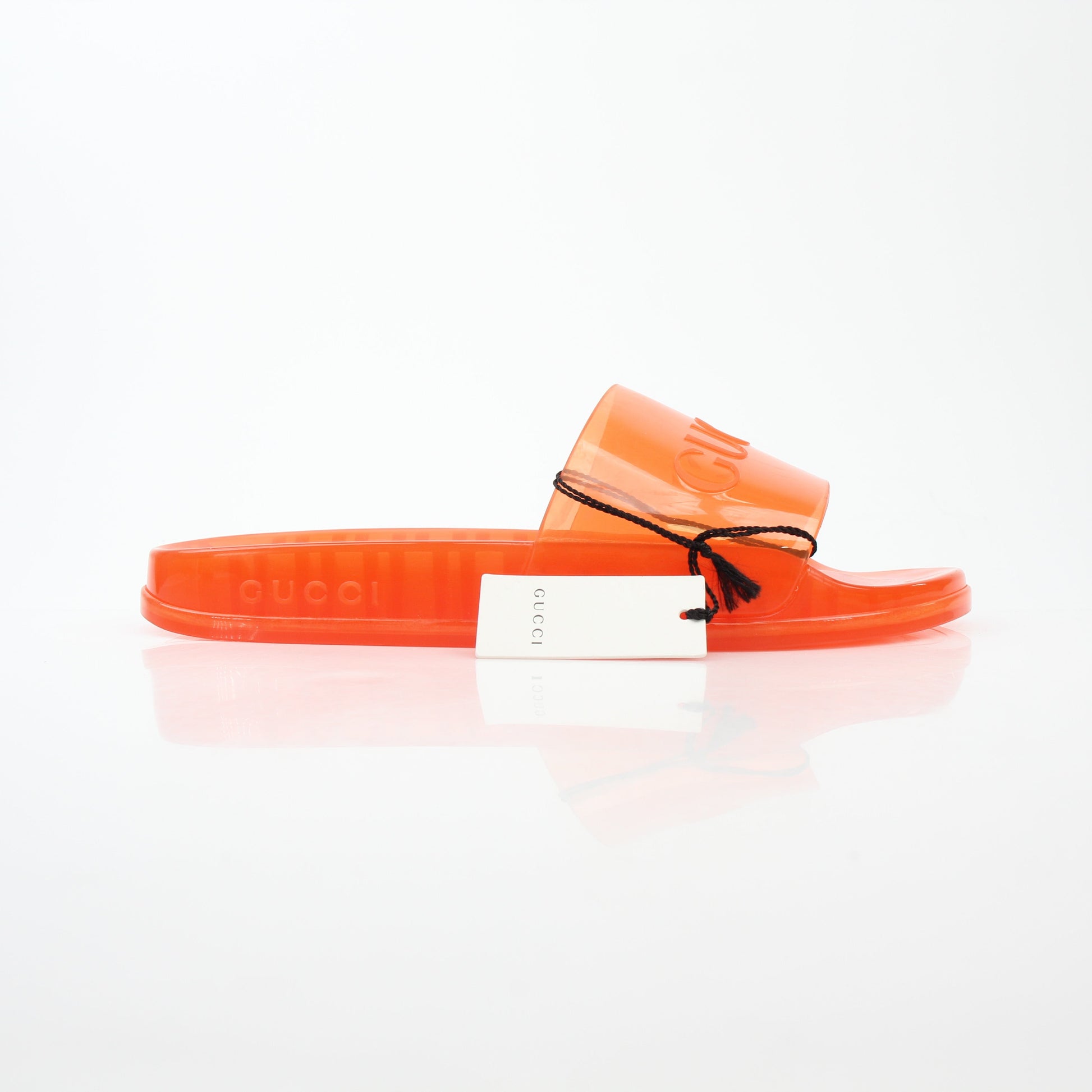 Gucci orange Pursuit logo slide sandals with branded straps and casual slip-on design, shown on a white background.