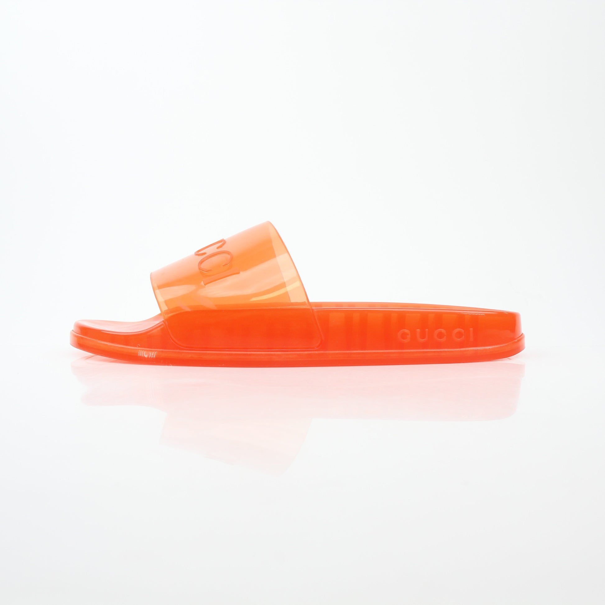 Gucci orange Pursuit logo slide sandals with cushioned straps and flat soles, designed for comfortable, stylish wear.