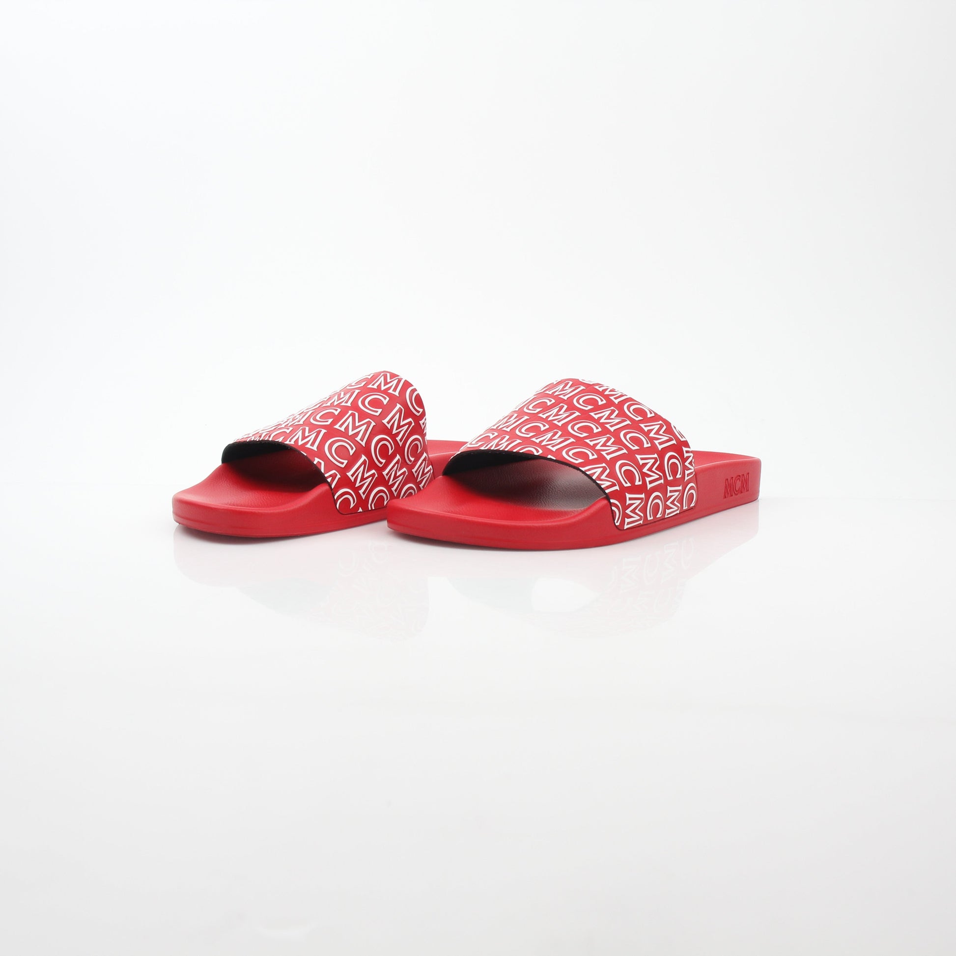Gold & Beyond MCM red logo print slide sandals with open toe and comfortable slip-on design.