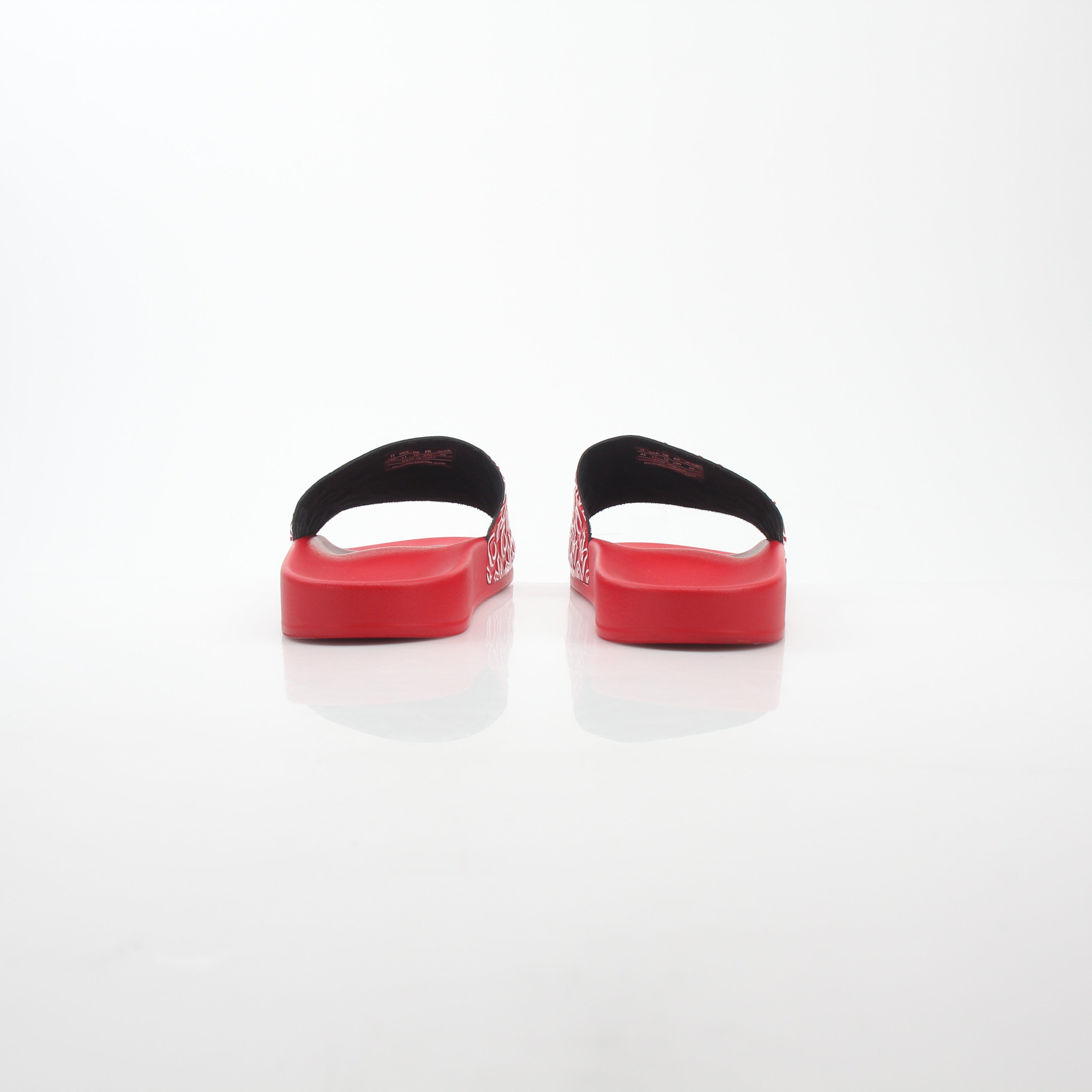 Red MCM logo print slide sandals by Gold & Beyond, featuring comfortable open-toe design and bold branding.