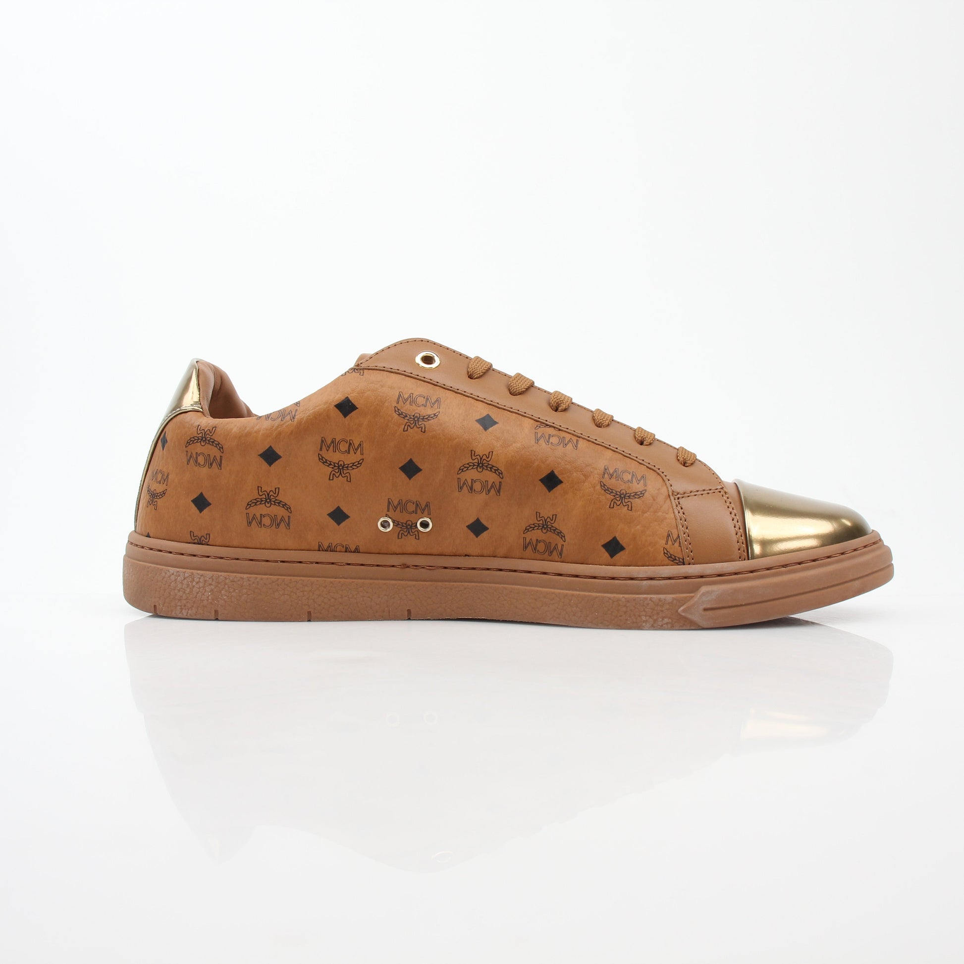 Gold & Beyond MCM Cognac Terrain low-top sneakers with textured leather and white rubber soles, stylish casual shoes.