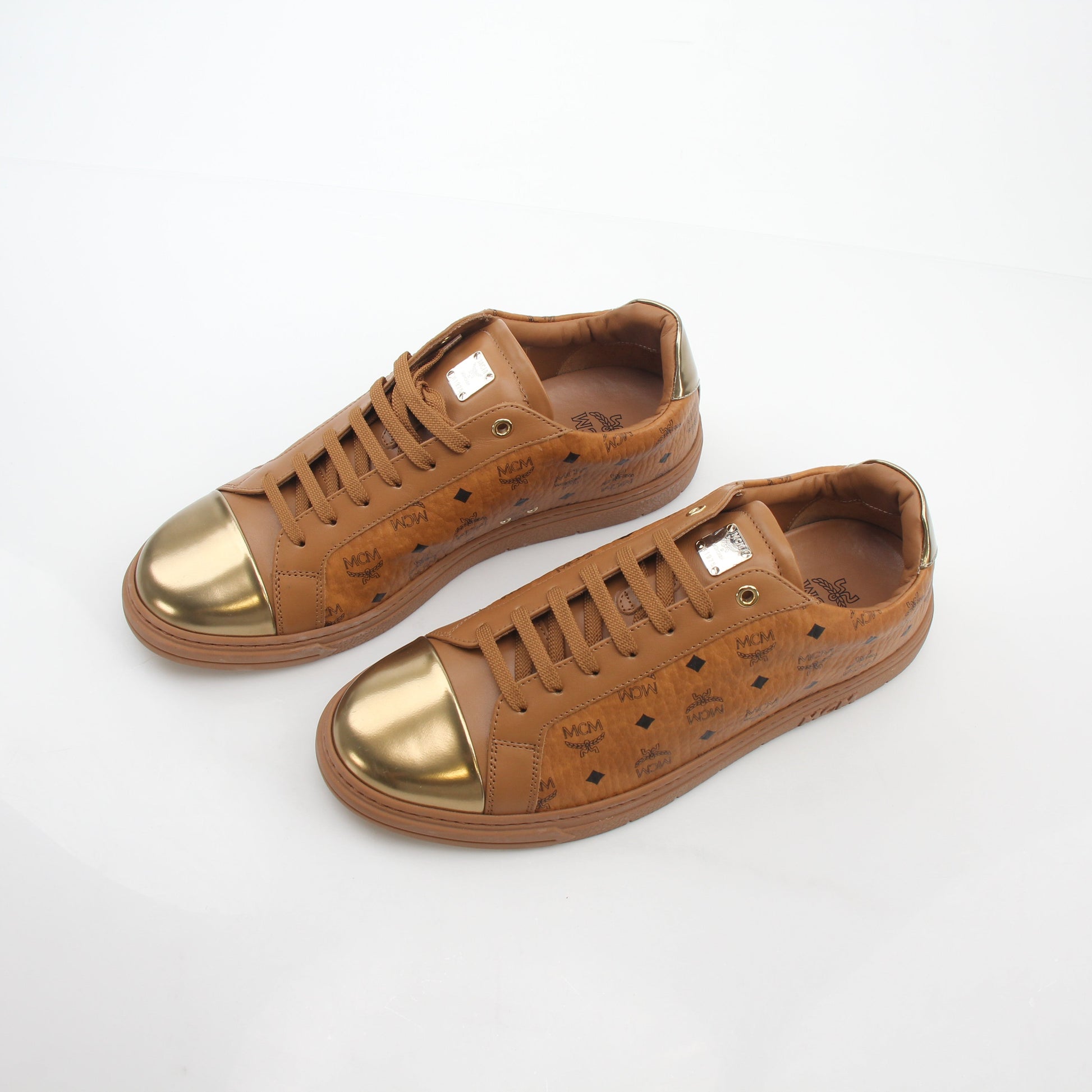 Gold & Beyond MCM Cognac Terrain low-top sneakers showing beige and brown leather and fabric details with white soles.