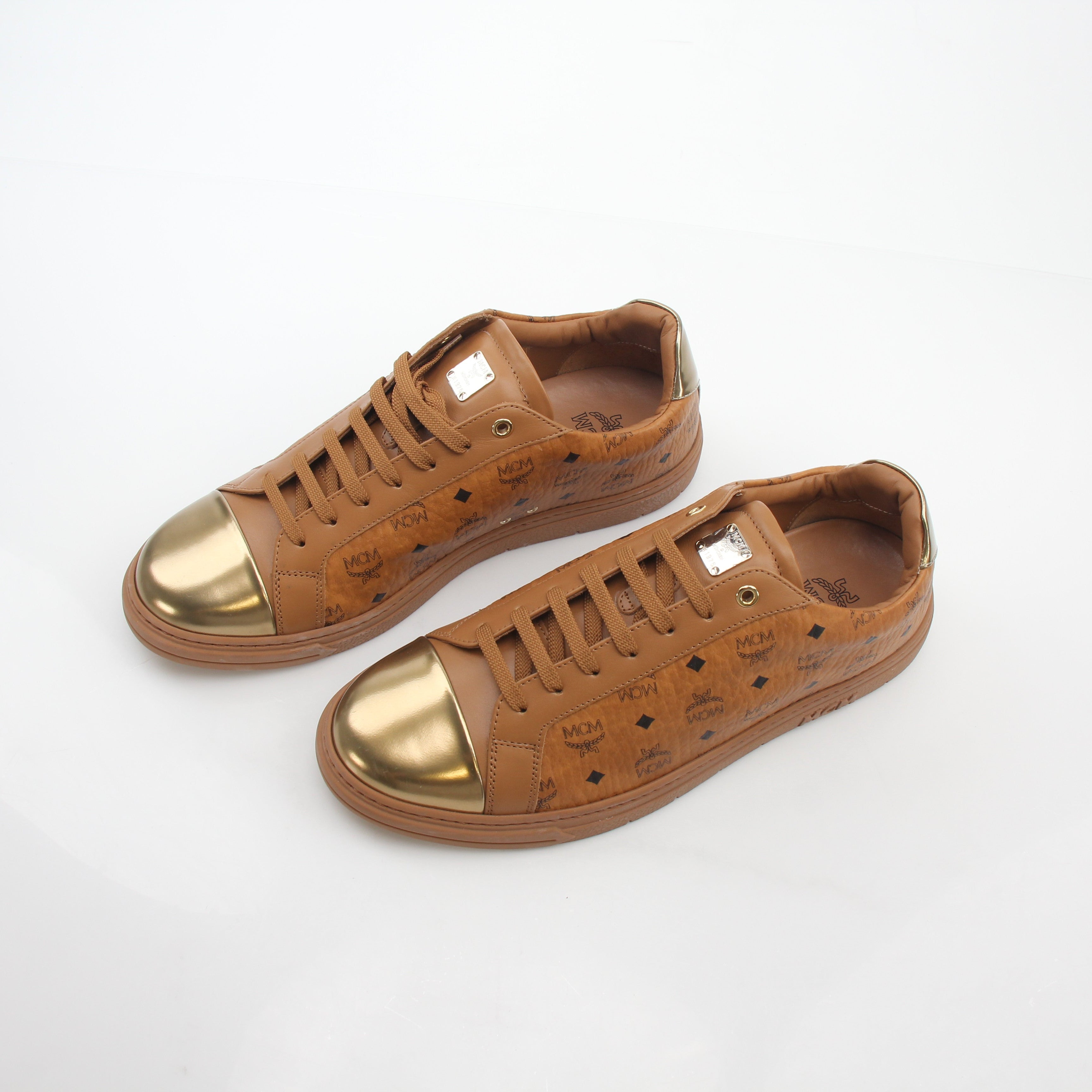 Gold & Beyond MCM Cognac Terrain low-top sneakers showing beige and brown leather and fabric details with white soles.