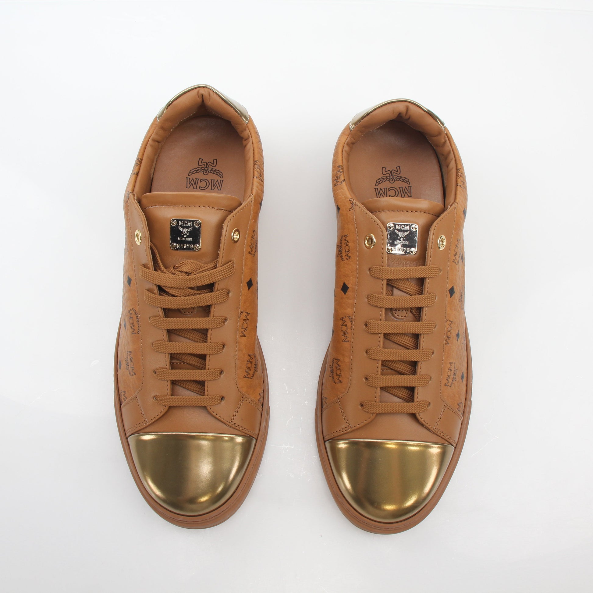 Gold & Beyond MCM Cognac Terrain low-top sneakers with beige accents and textured sole, stylish men's shoes.