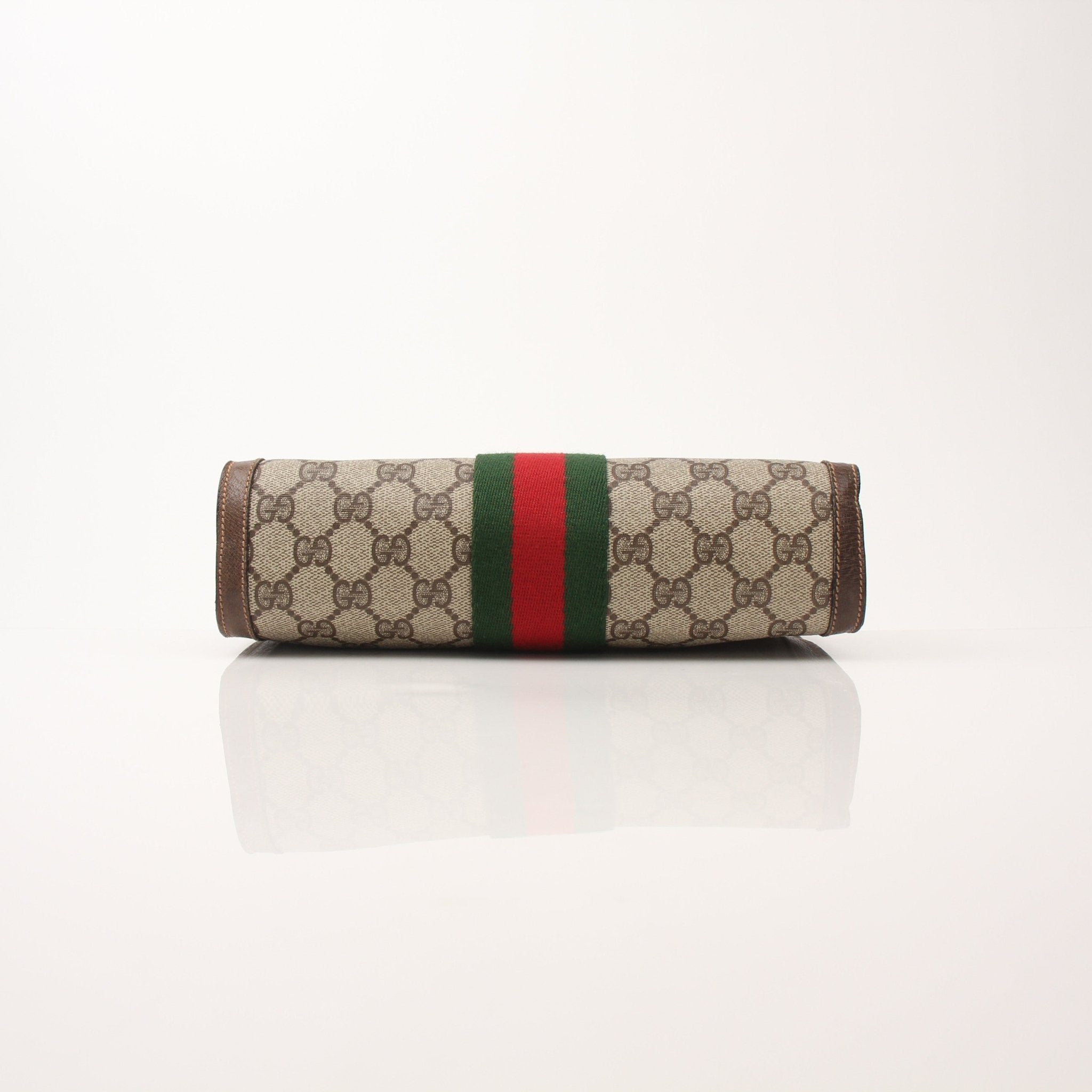 Gold & Beyond Gucci vintage clutch handbag with elegant design and gold accents, showcased on a neutral background.