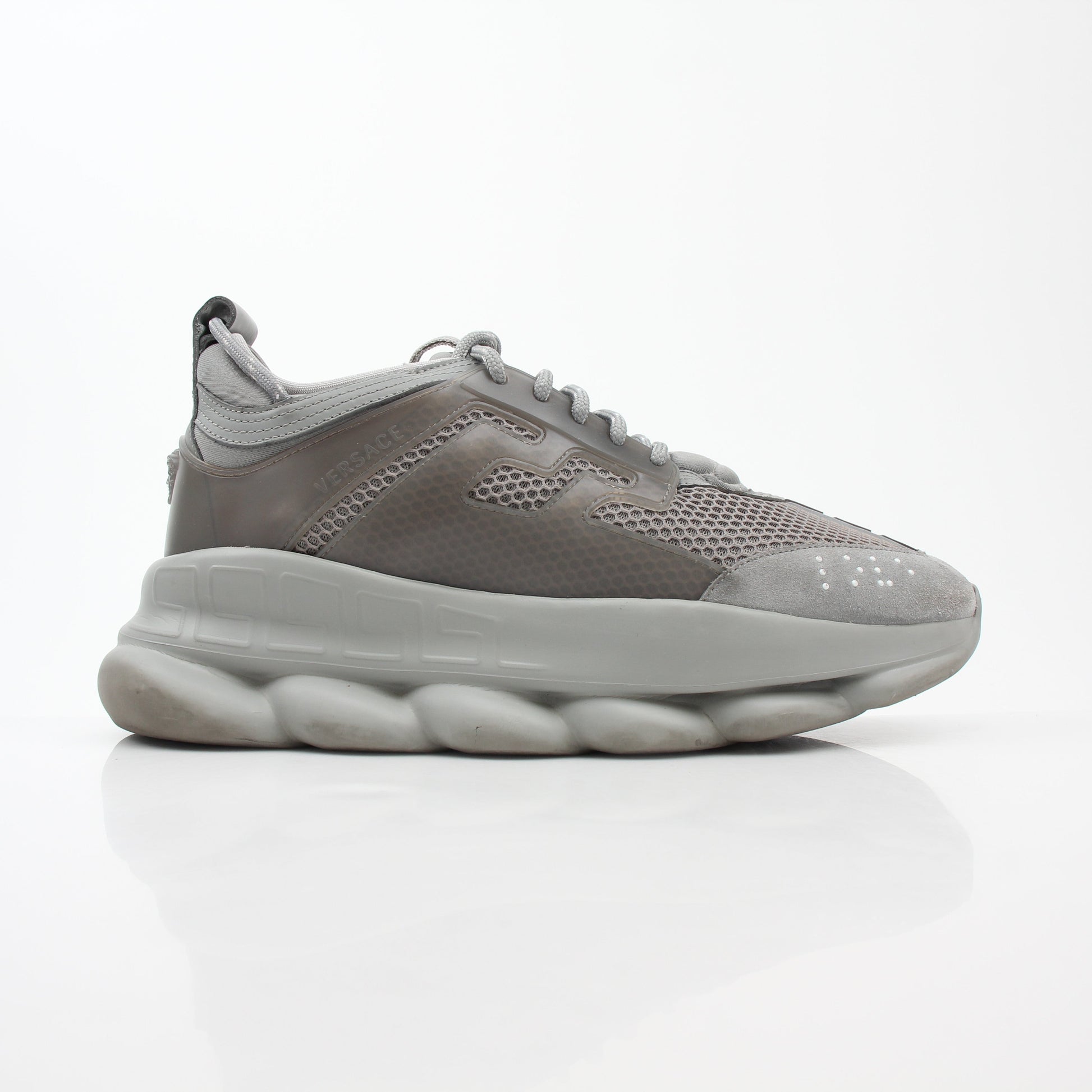 Gray Versace Chain Reaction sneakers by Gold & Beyond featuring a sleek design with chain details and stylish athletic shoes.