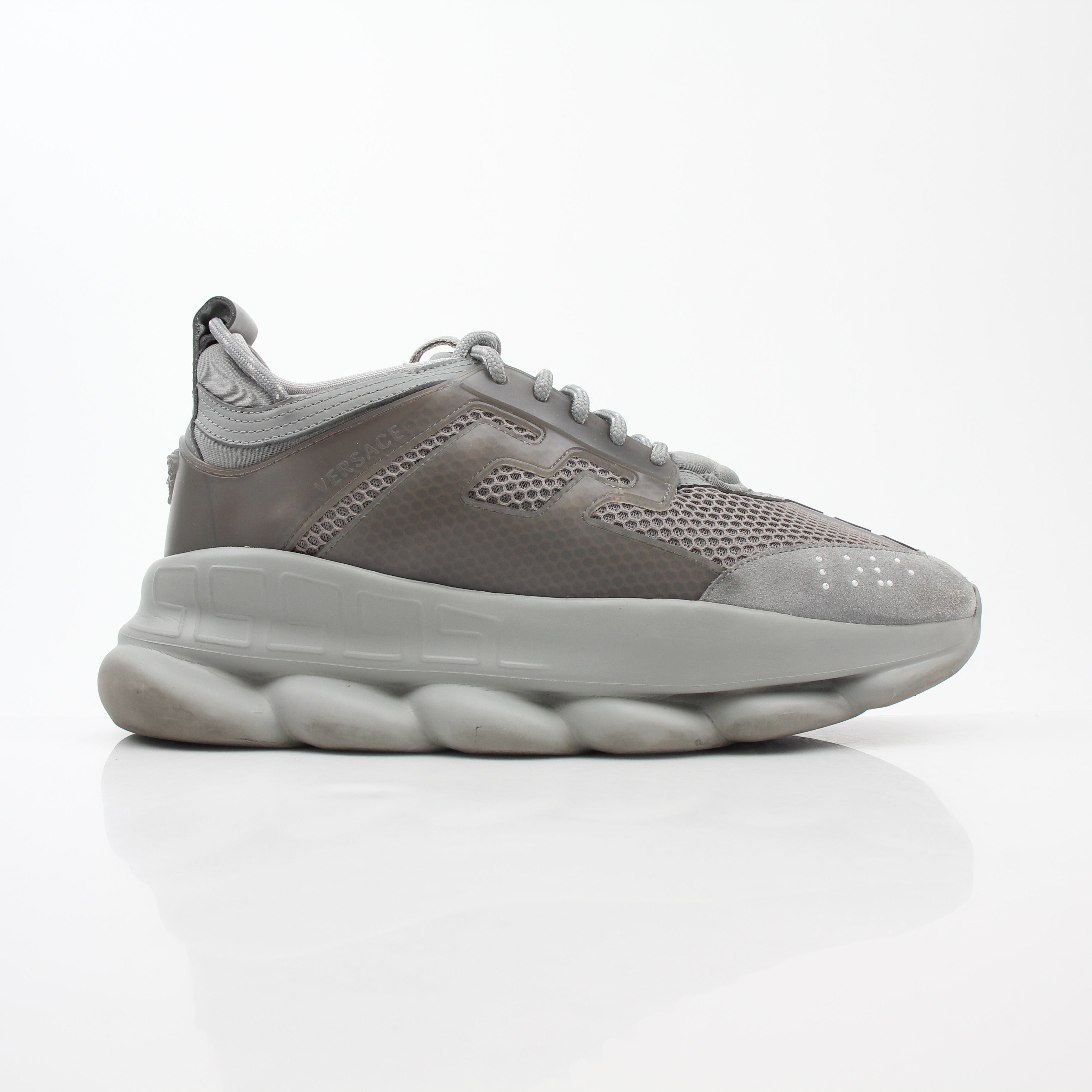 Gray Versace Chain Reaction sneakers by Gold & Beyond featuring a sleek design with chain details and stylish athletic shoes.
