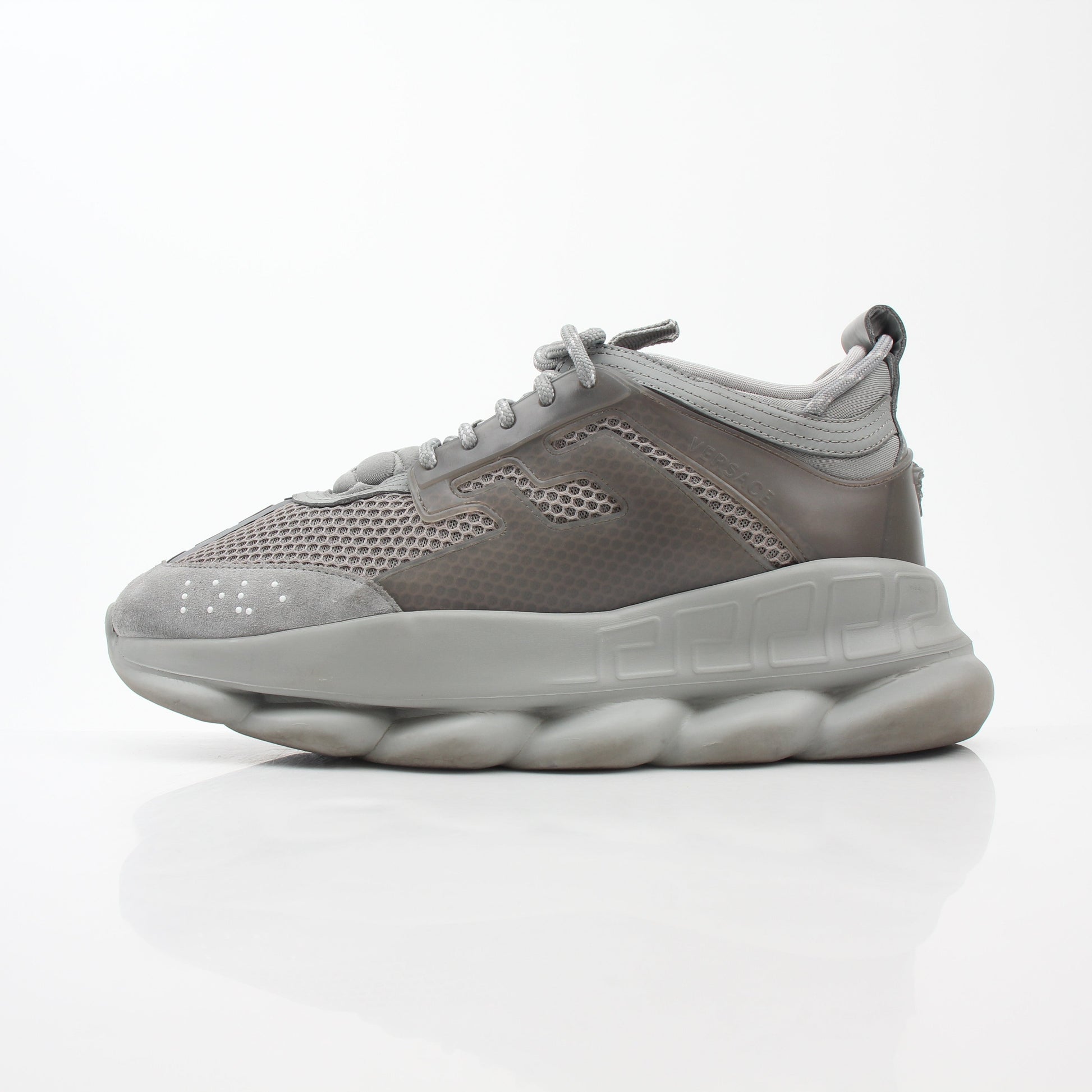 Versace Gray Chain Reaction sneakers from Gold & Beyond featuring stylish gray shoes with chain details and sporty design.