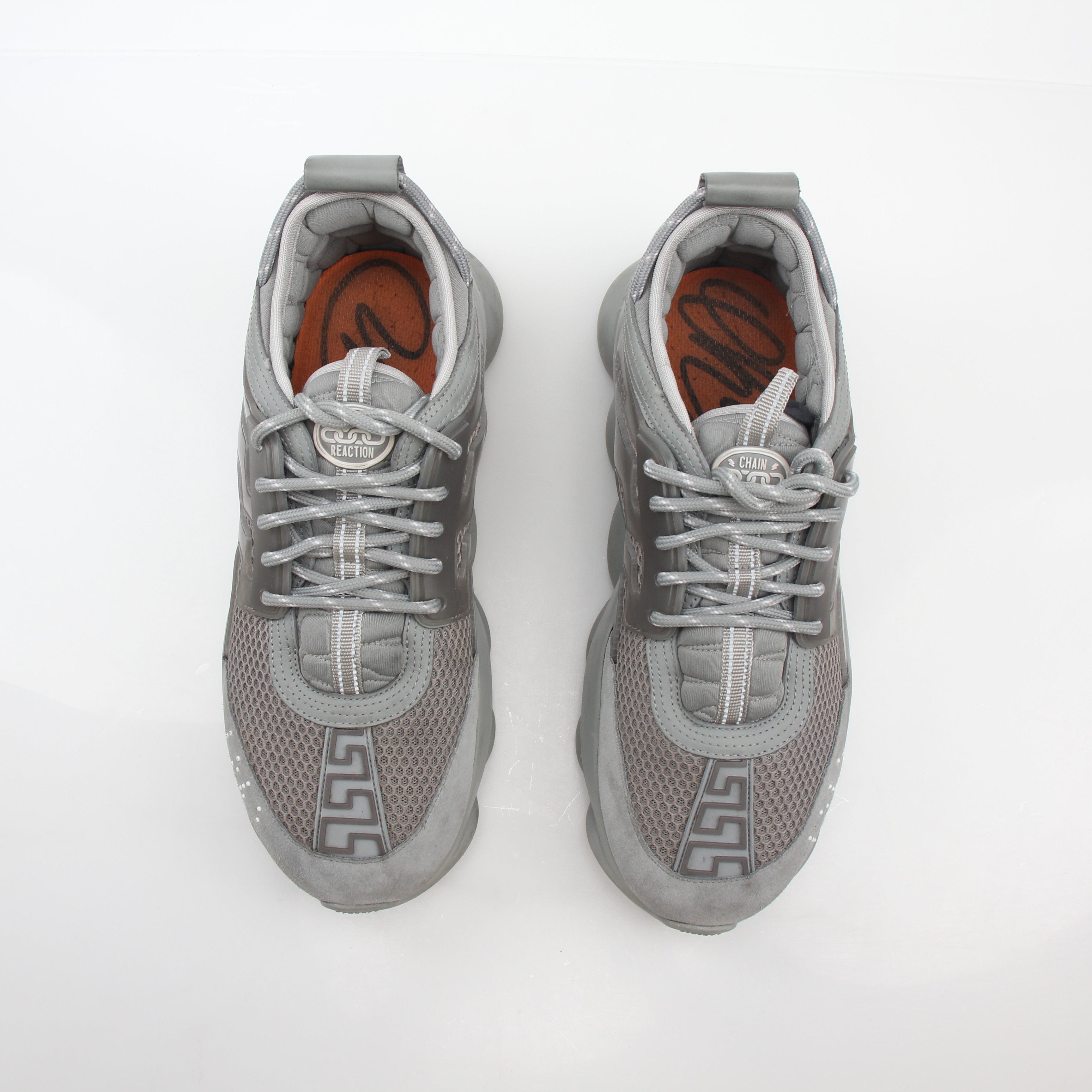 Versace Gray Chain Reaction sneakers by Gold & Beyond featuring stylish gray athletic shoes with chain detail and modern design.