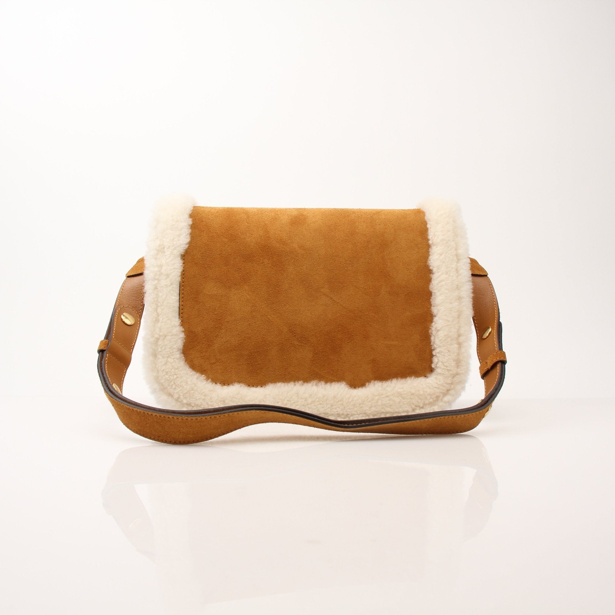Gucci suede shearling Horsebit 1955 shoulder handbag with gold accents and leather strap, displayed on a neutral background.