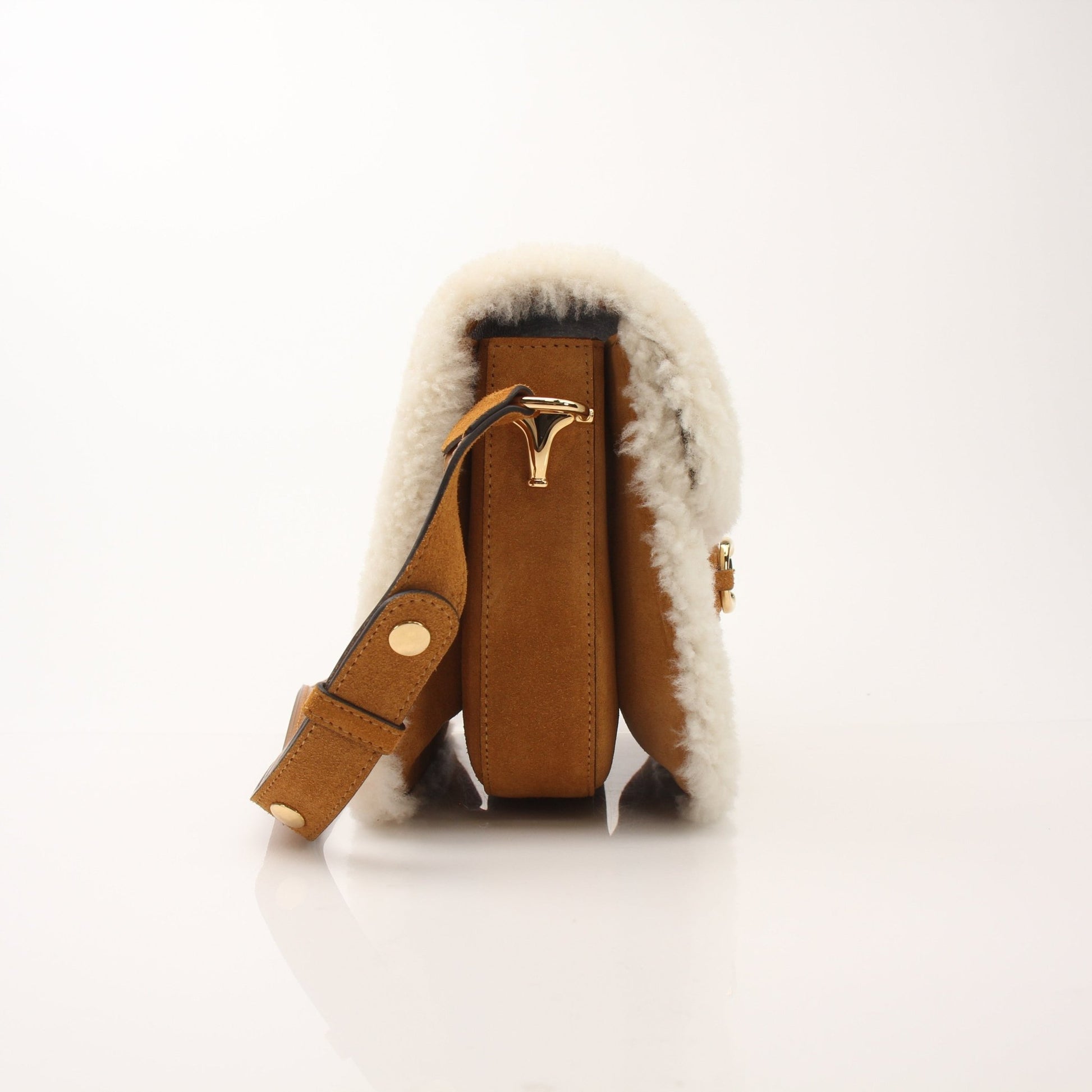 Gucci suede shearling Horsebit 1955 shoulder handbag with gold hardware, featuring a soft shearling interior and stylish design.