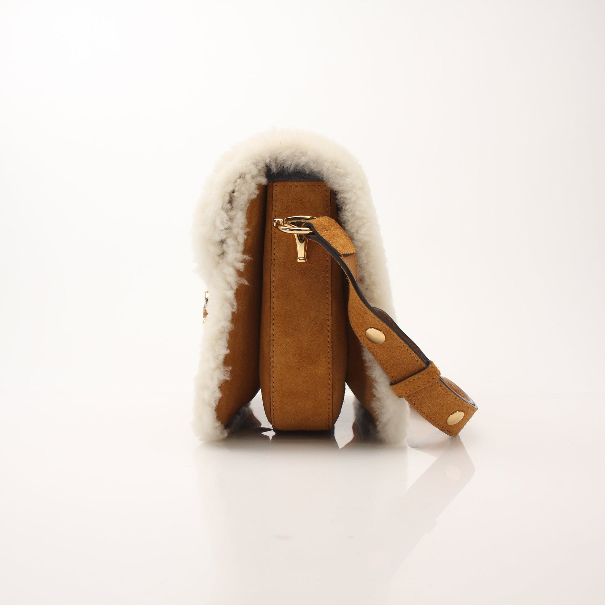 Gucci suede shearling Horsebit 1955 shoulder handbag with gold hardware, featuring a luxurious textured design and structured shape.