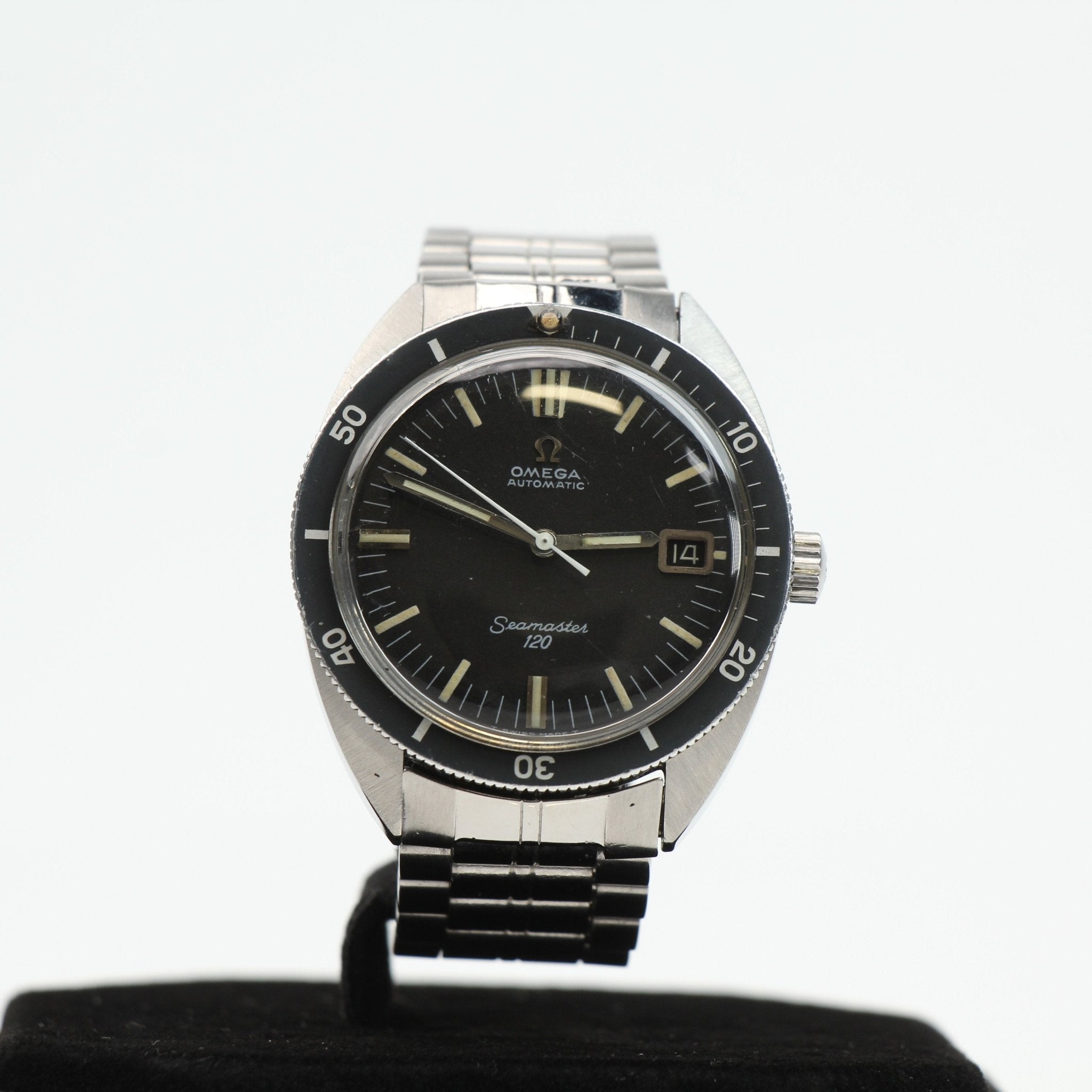Vintage Omega Seamaster 120 diver watch with black dial, stainless steel case, and rotating bezel, displayed on a white background.