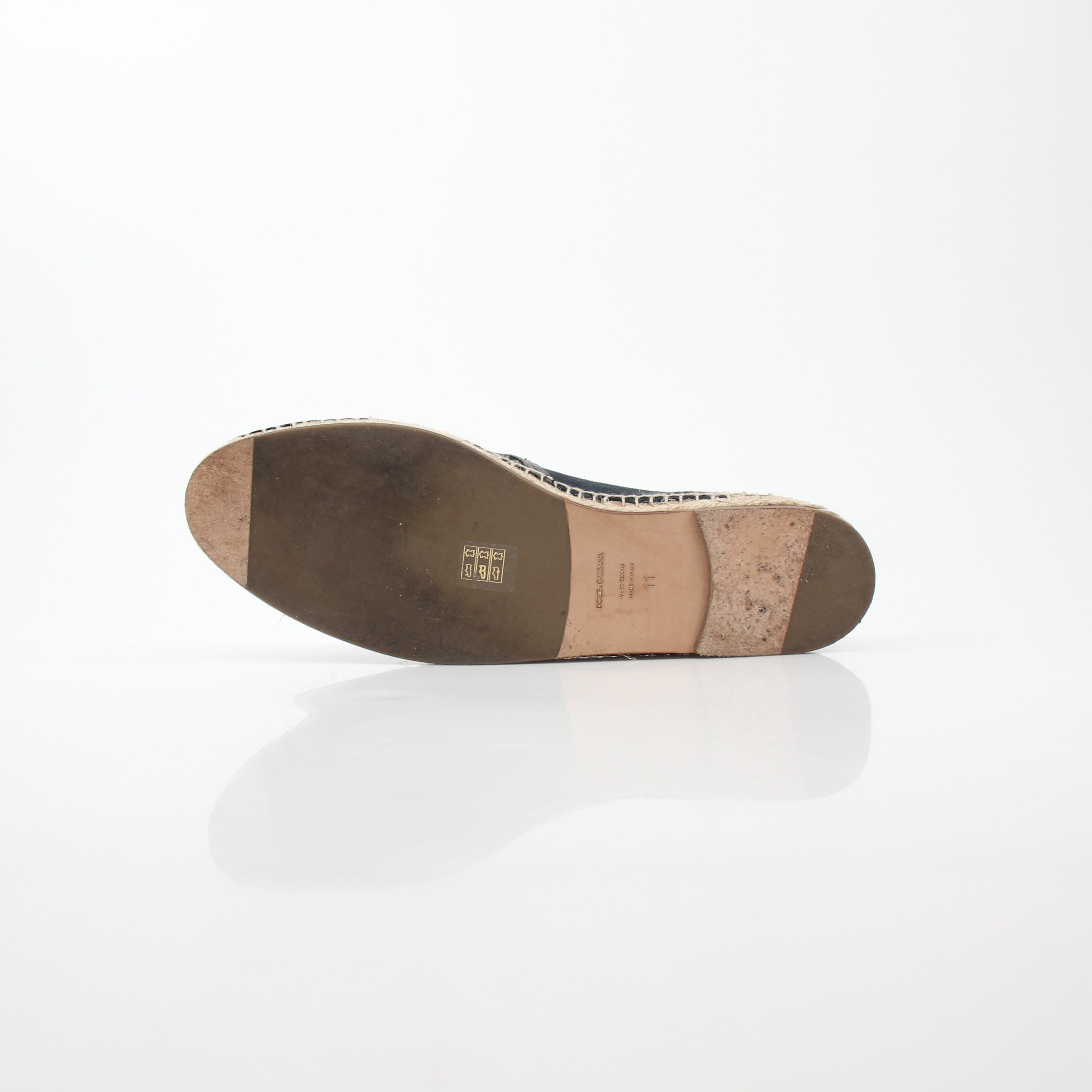 Black suede Dolce & Gabbana espadrille shoes with woven jute sole and slip-on design, displayed on a neutral background.