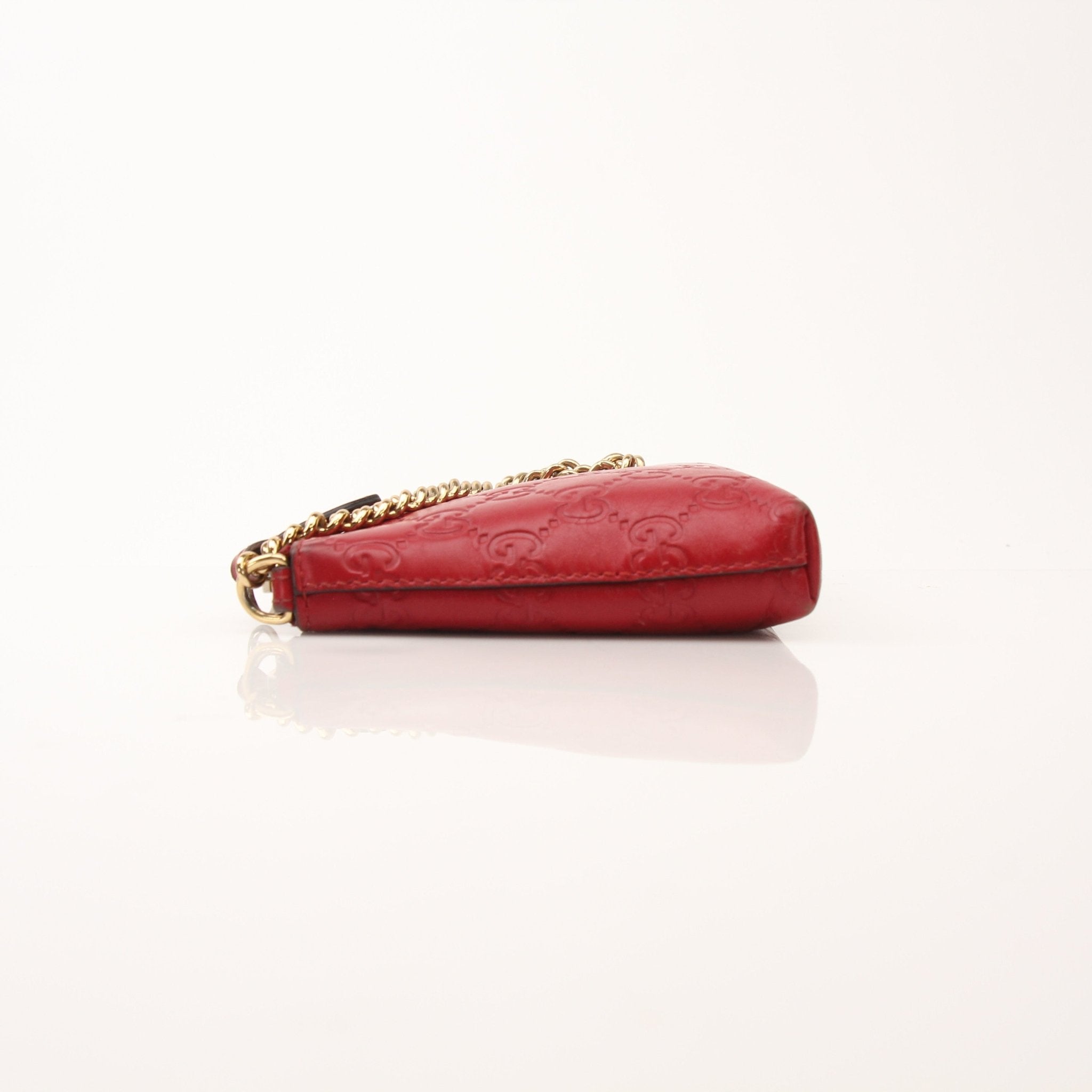 Gucci Guccissima leather chain shoulder handbag with gold-tone hardware and structured design for stylish everyday use.
