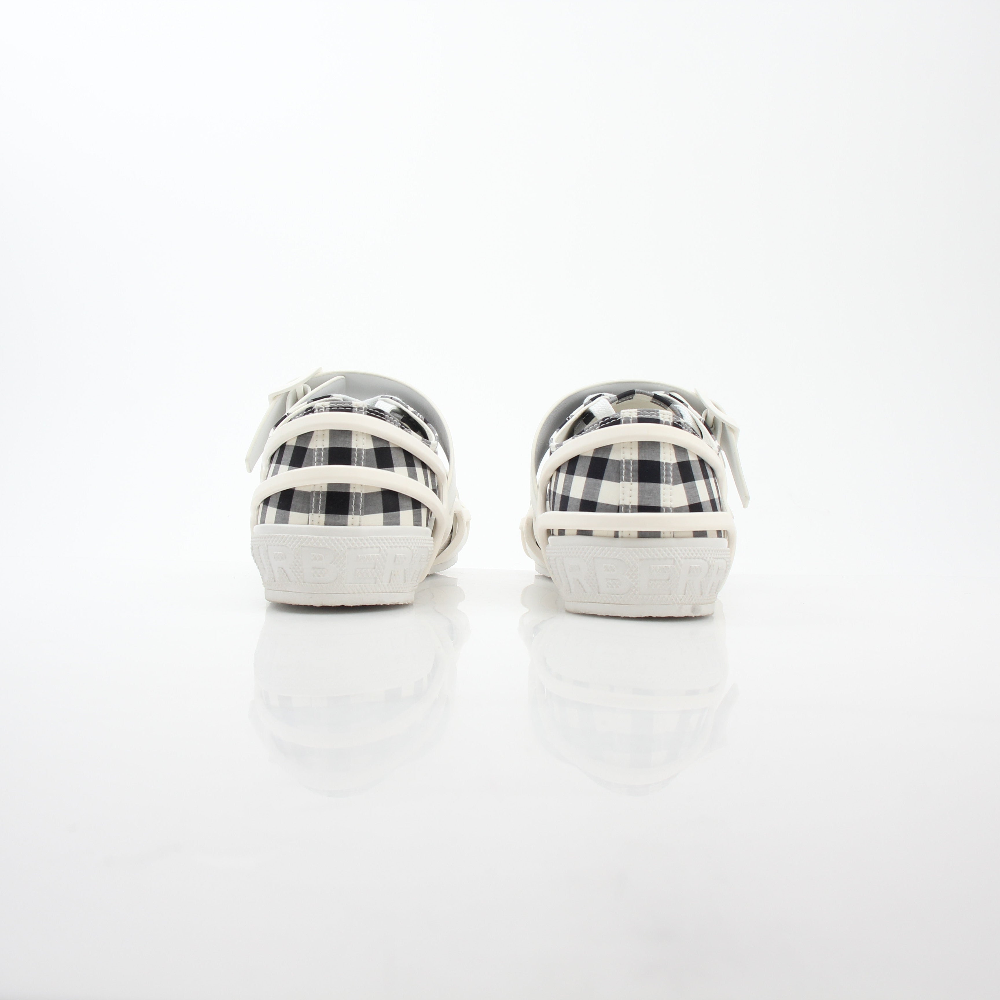 Gold & Beyond Burberry black and white gingham Webb low-top sneakers, showing classic check pattern and white rubber sole.