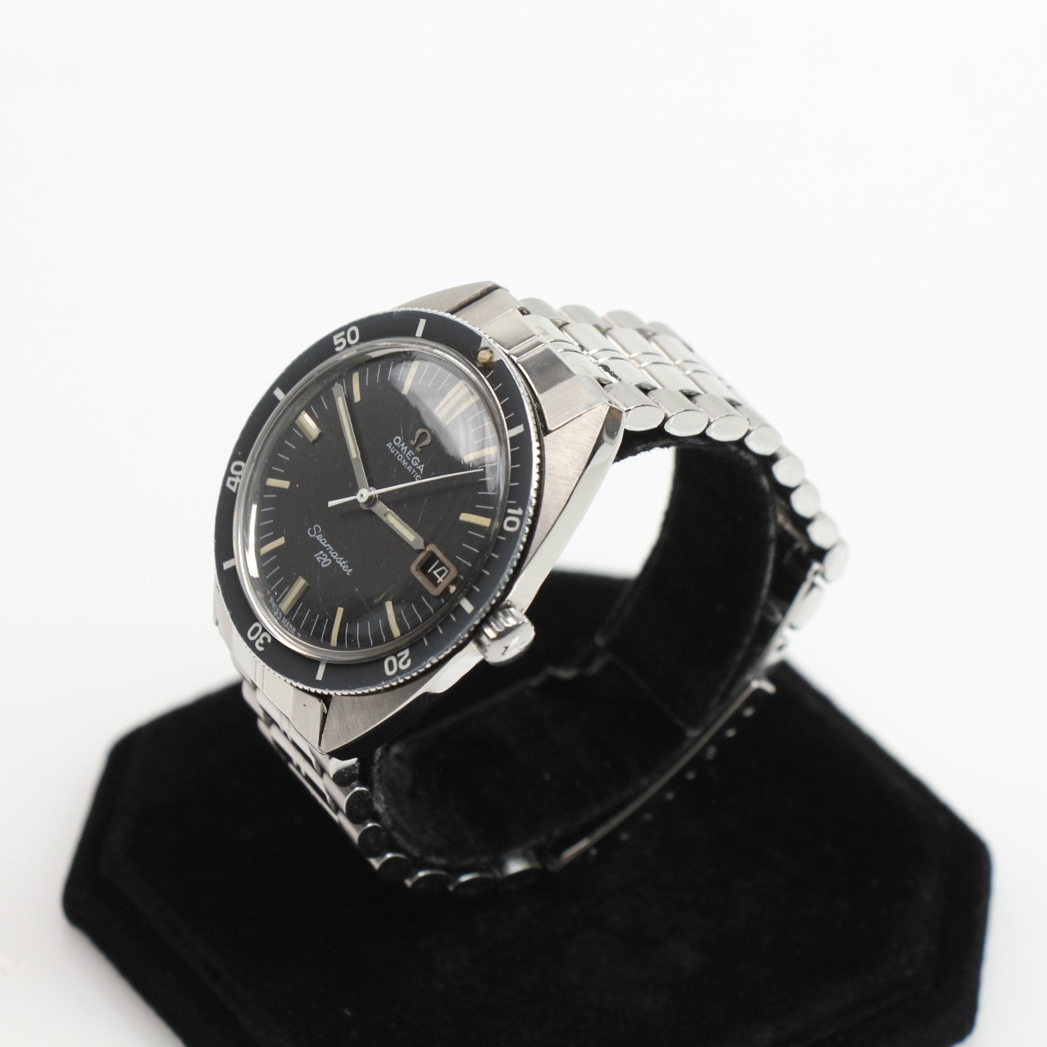Omega Seamaster 120 vintage diver watch with a black dial, stainless steel case, and rotating bezel displayed in the image.
