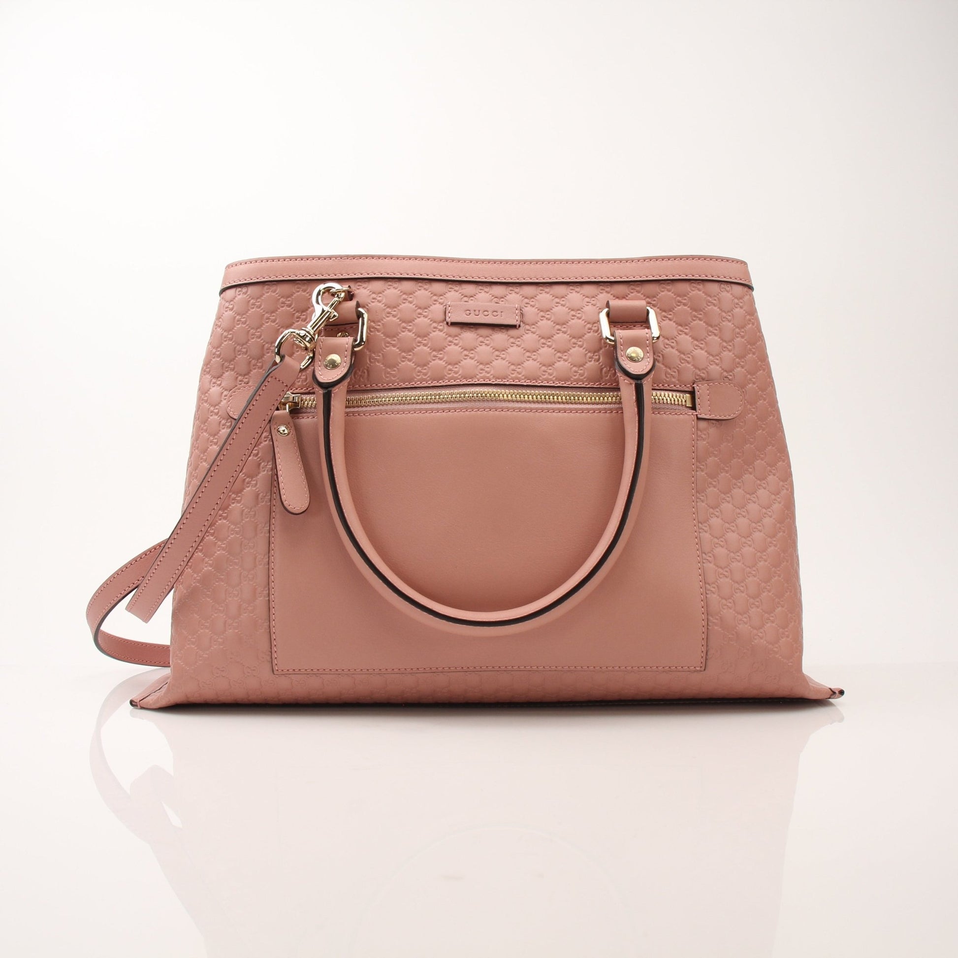 Gold & Beyond Gucci Micro Guccissima top handle tote bag, black leather handbag with gold hardware and structured design.