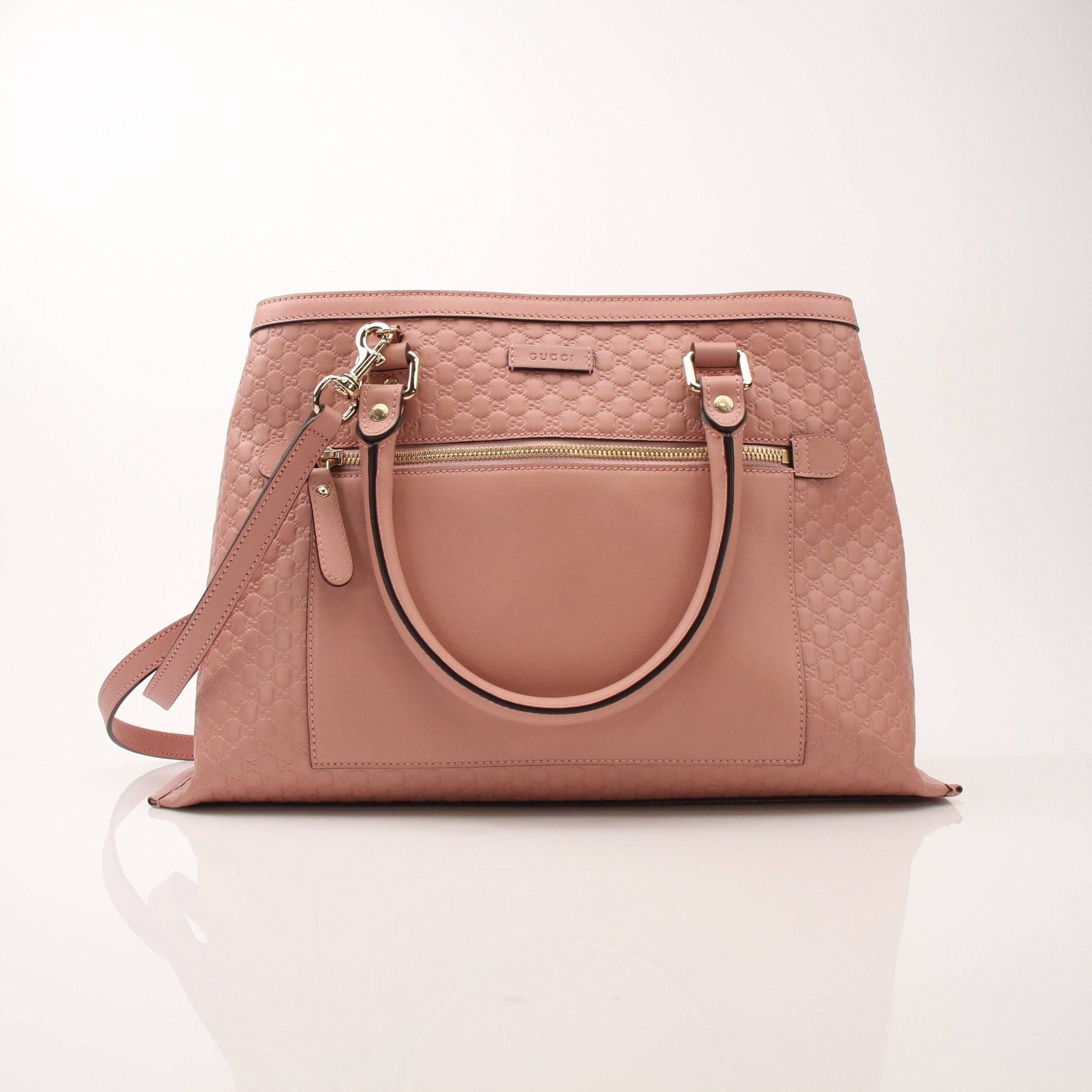 Gold & Beyond Gucci Micro Guccissima top handle tote bag, black leather handbag with gold hardware and structured design.