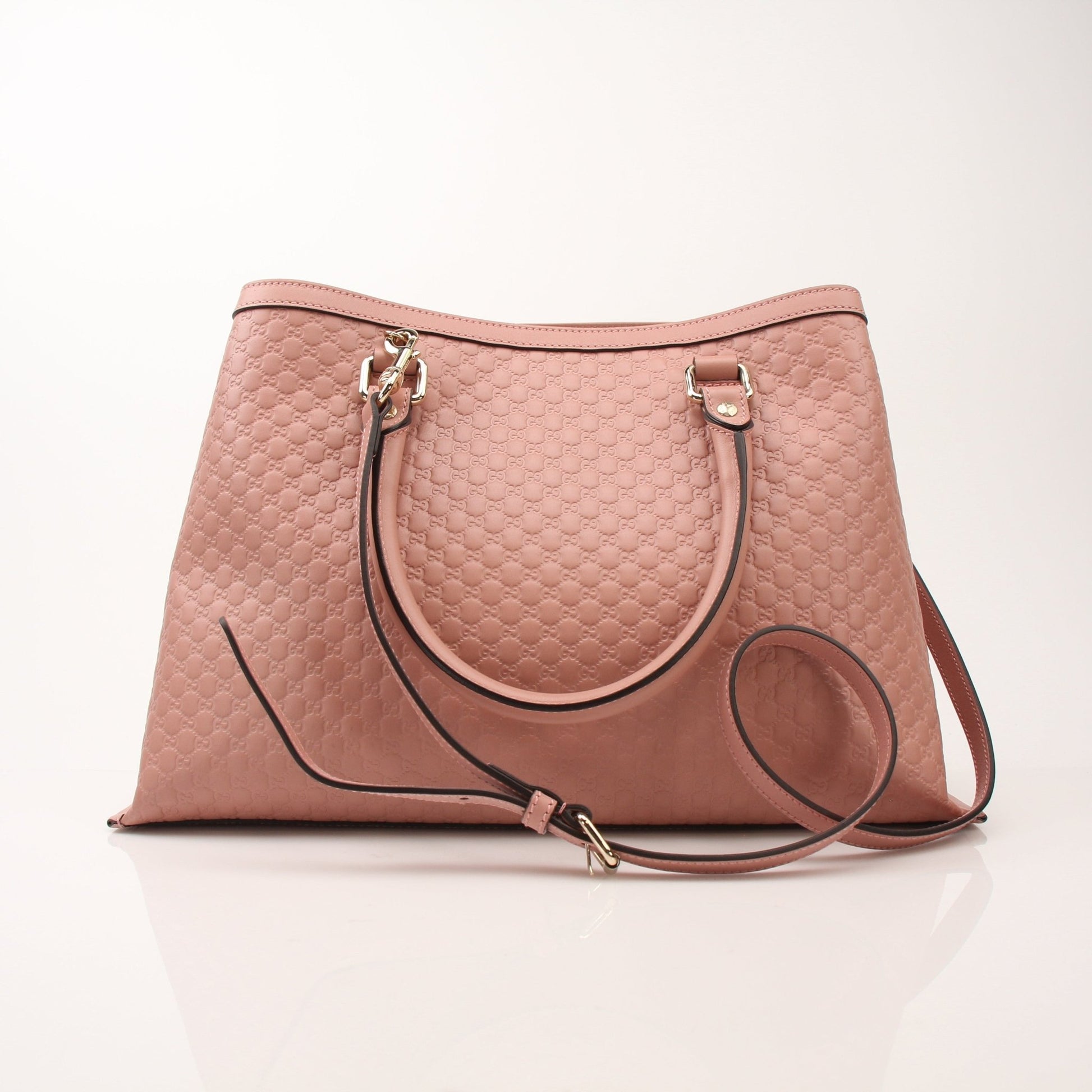 Gold & Beyond Gucci Micro Guccissima top handle tote bag with structured design and leather handles, featuring signature monogram pattern.