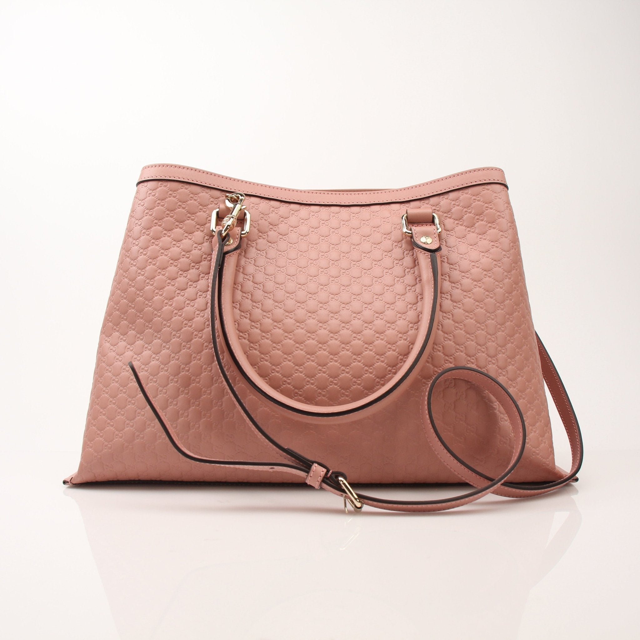 Gold & Beyond Gucci Micro Guccissima top handle tote bag with structured design and leather handles, featuring signature monogram pattern.