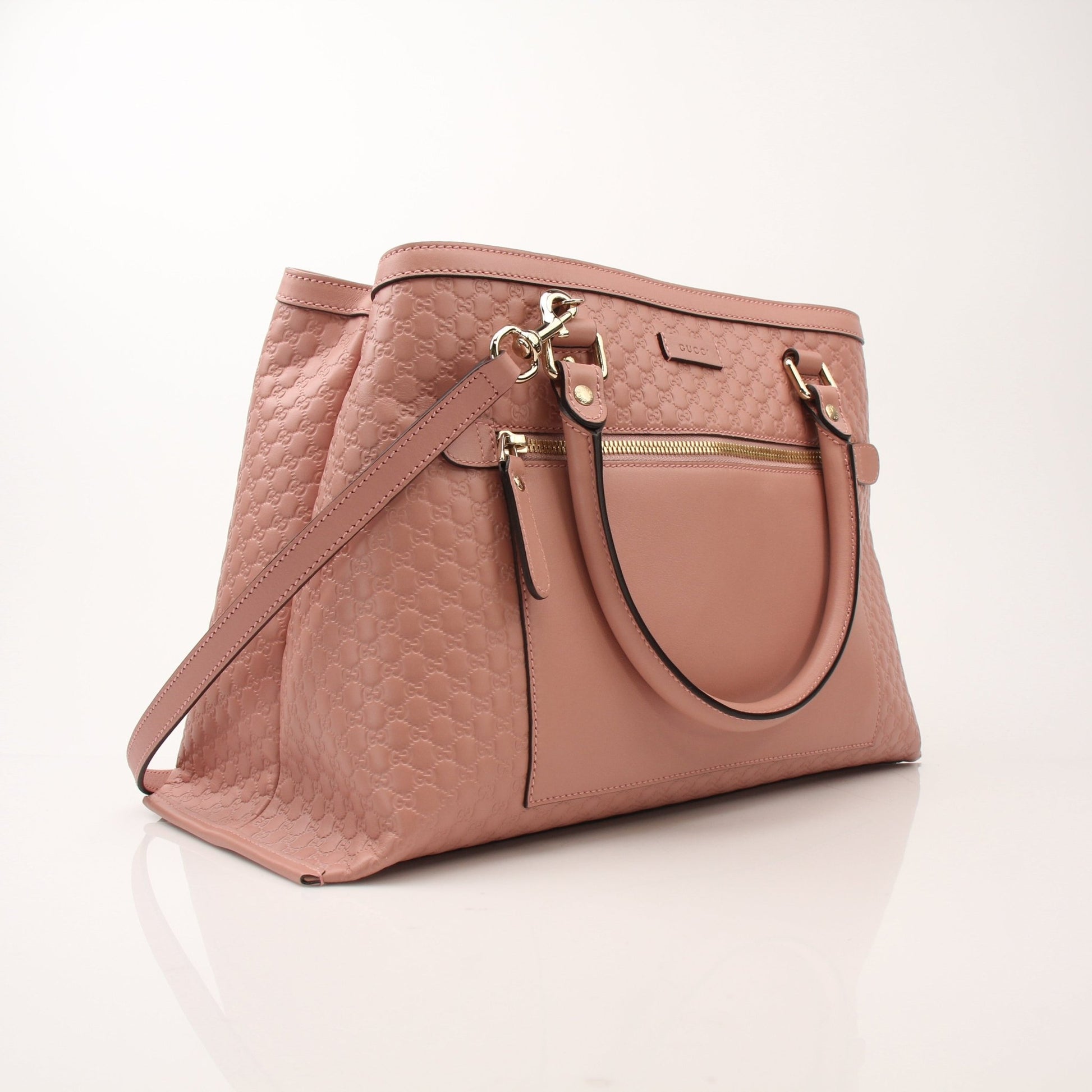 Gold & Beyond Gucci Micro Guccissima top handle tote bag showcasing textured leather, gold-tone hardware, and structured handbag design.