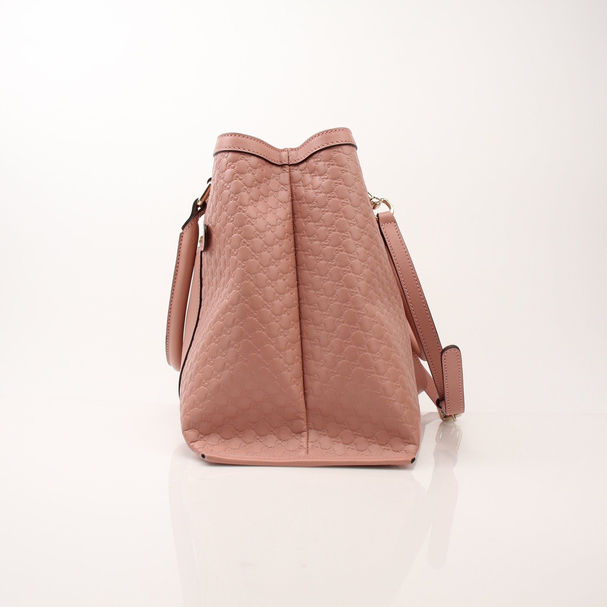 Gold & Beyond Gucci Micro Guccissima top handle tote bag, beige leather handbag with signature pattern and sturdy top handles.