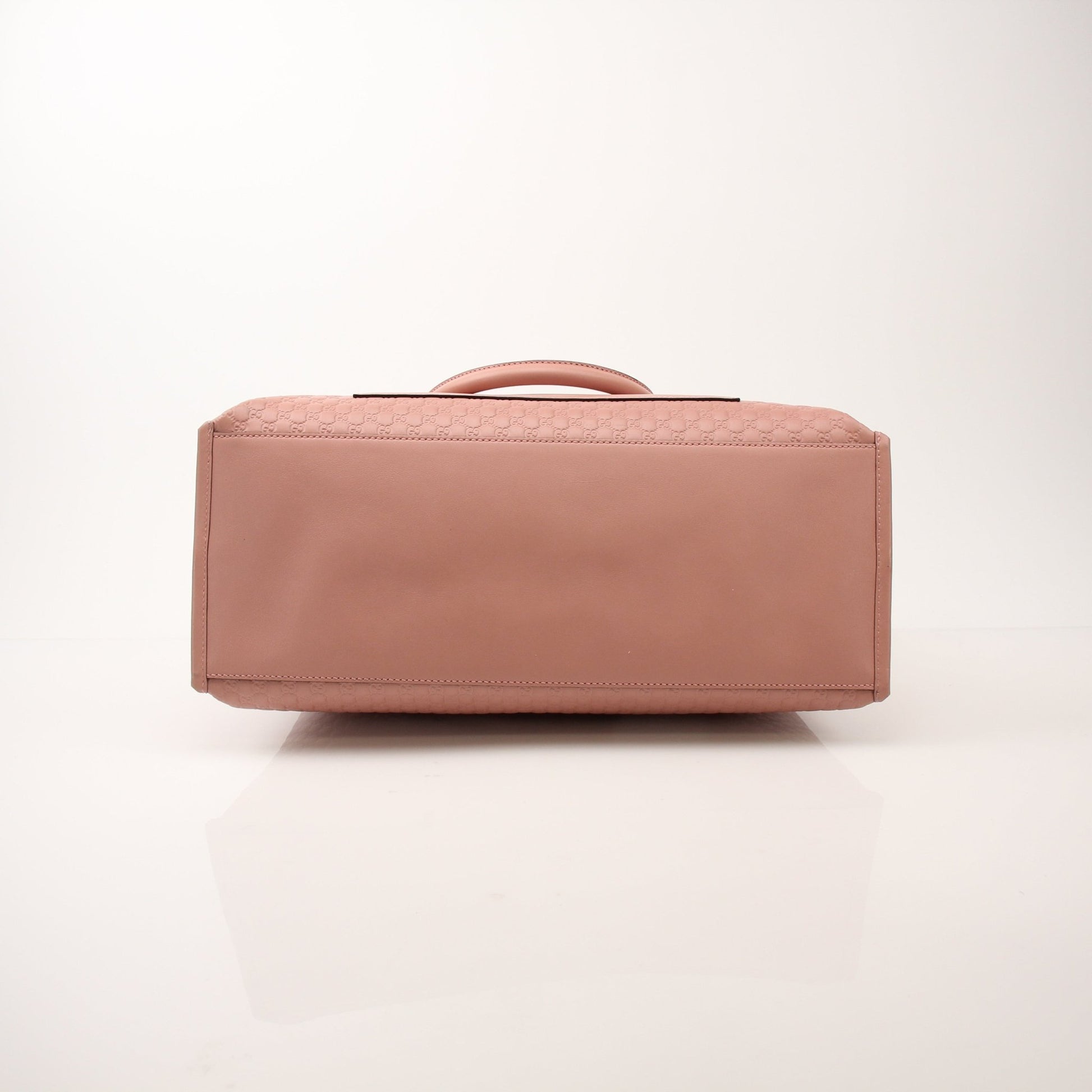Gold & Beyond Gucci Micro Guccissima top handle tote bag with structured design and leather handles, showcasing luxury handbag details.