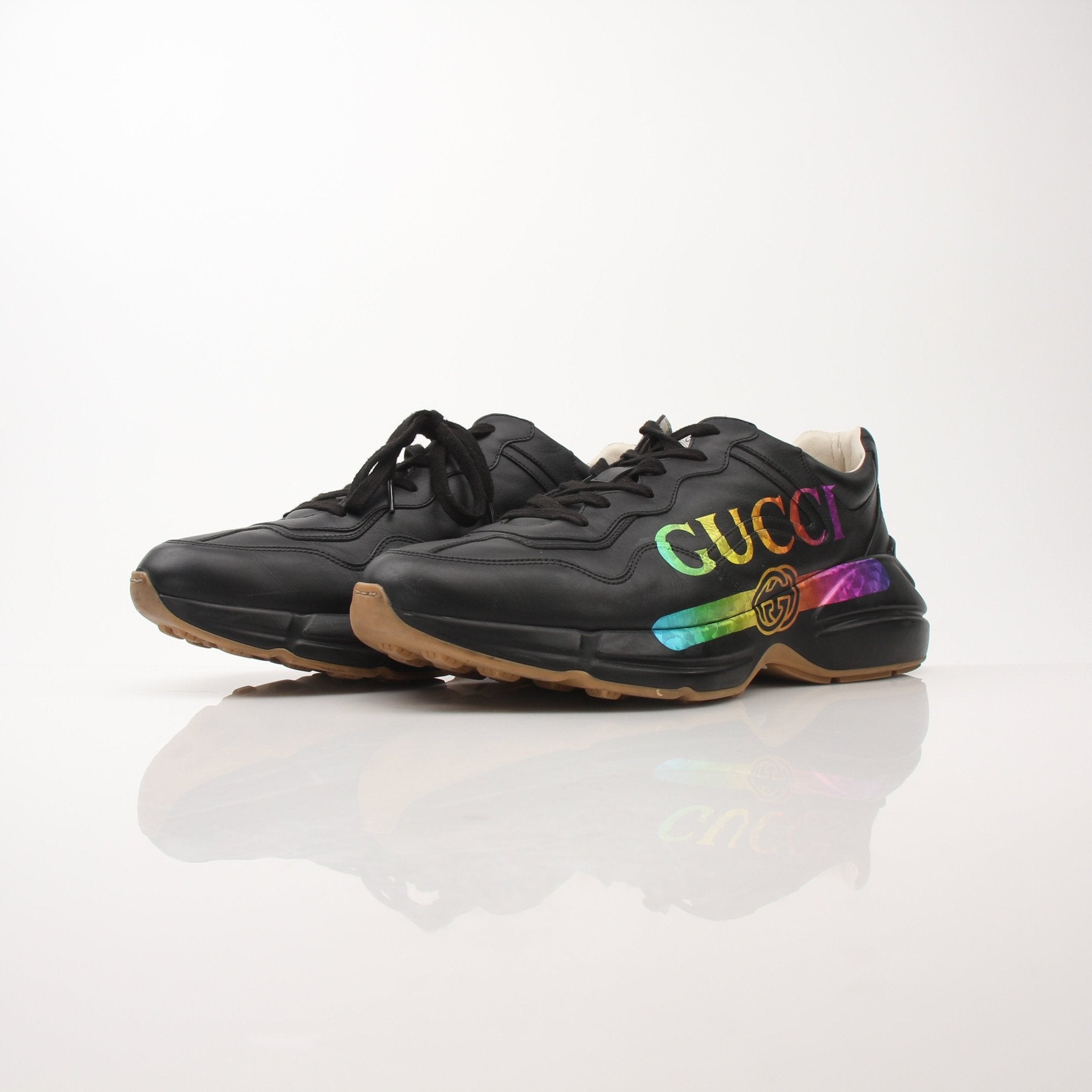 Gucci men's Rython iridescent logo sneakers featuring stylish design and reflective finish, displayed on a plain background.