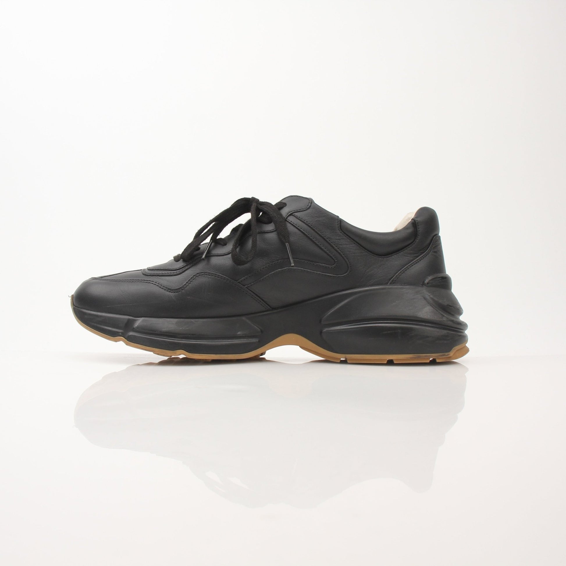 Gucci men's Rython iridescent logo sneakers with stylish design and gold accents, displayed on a clean background