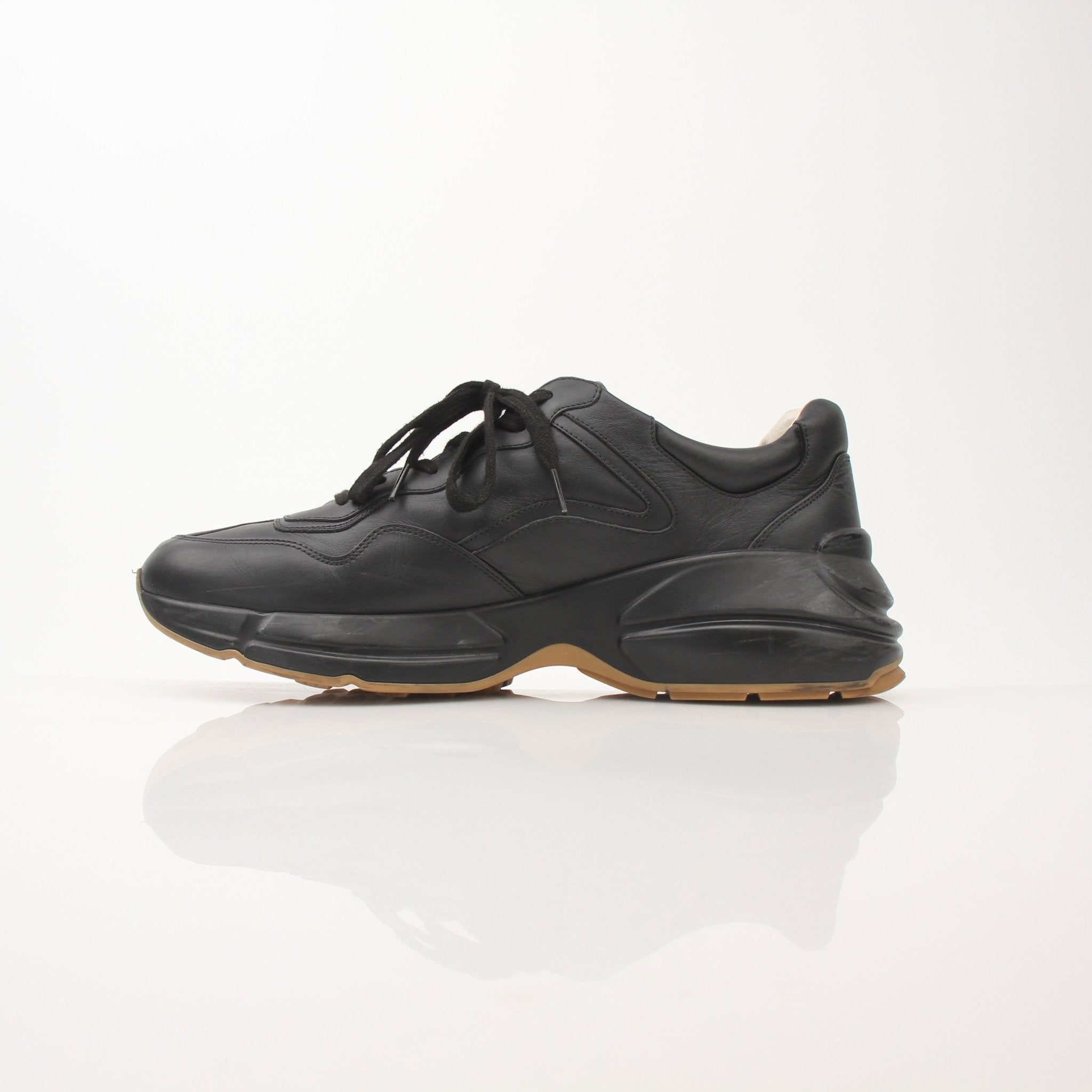 Gucci men's Rython iridescent logo sneakers with stylish design and gold accents, displayed on a clean background
