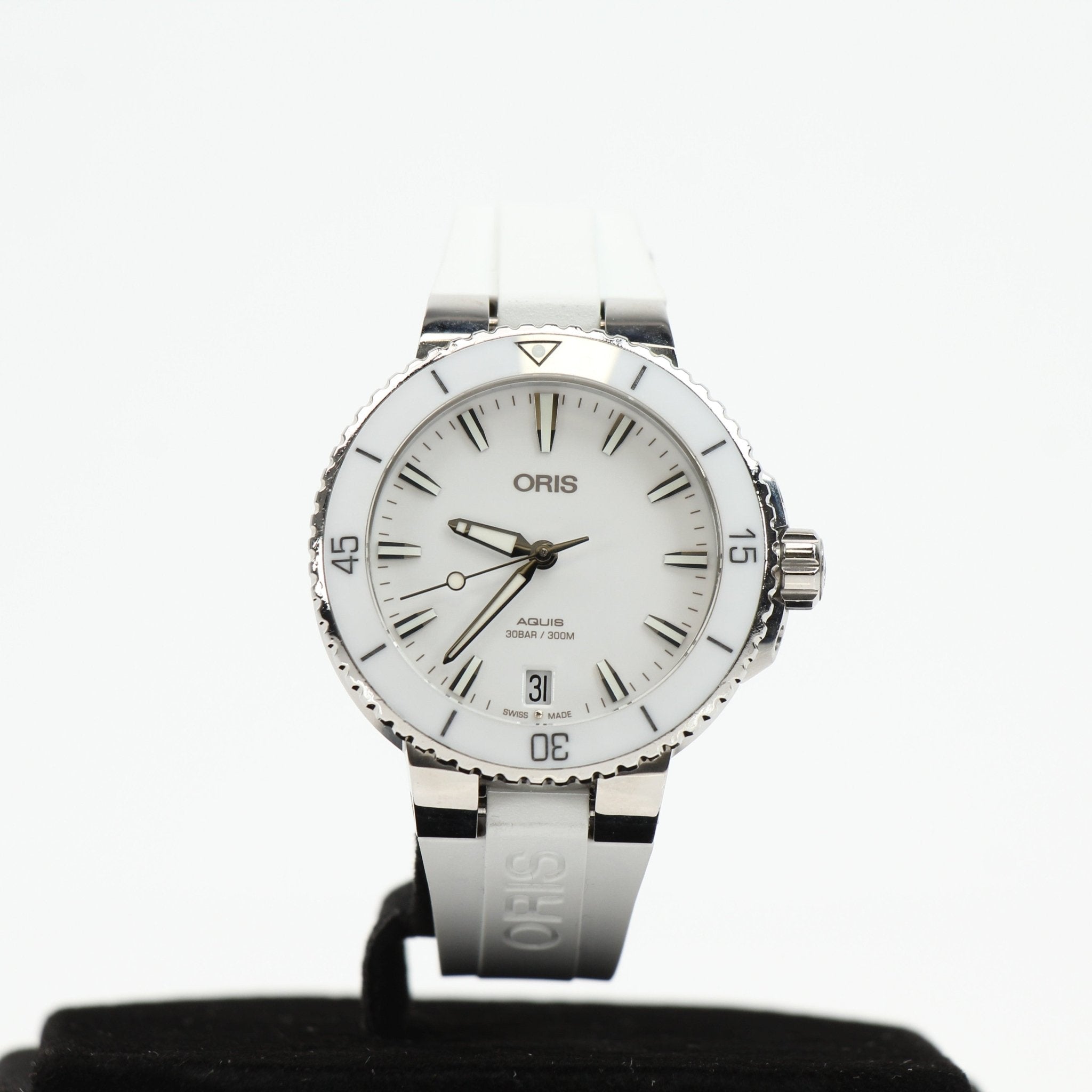 Oris Aquis Date White Diver Watch with stainless steel band and blue bezel showing time and date display.