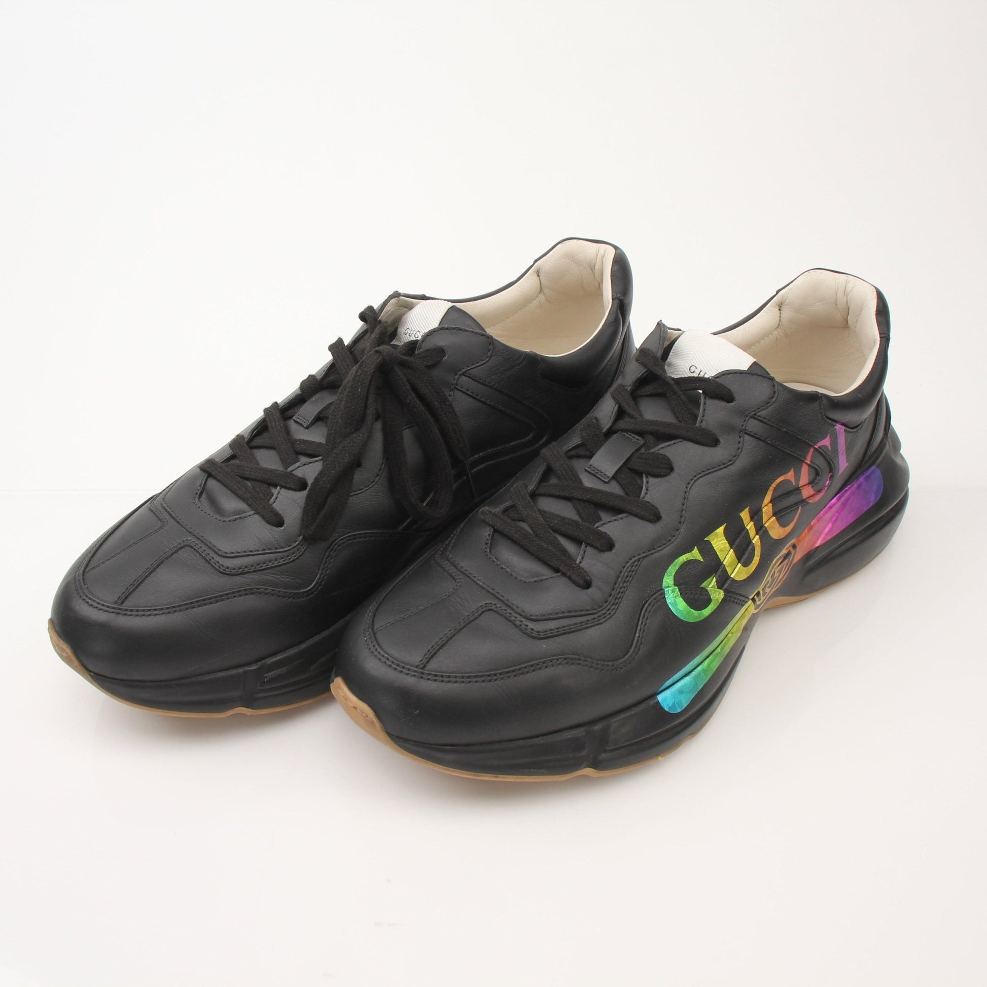 Gold & Beyond iridescent logo sneakers for men featuring a stylish Gucci Rython shoe design with reflective finish and sporty look.