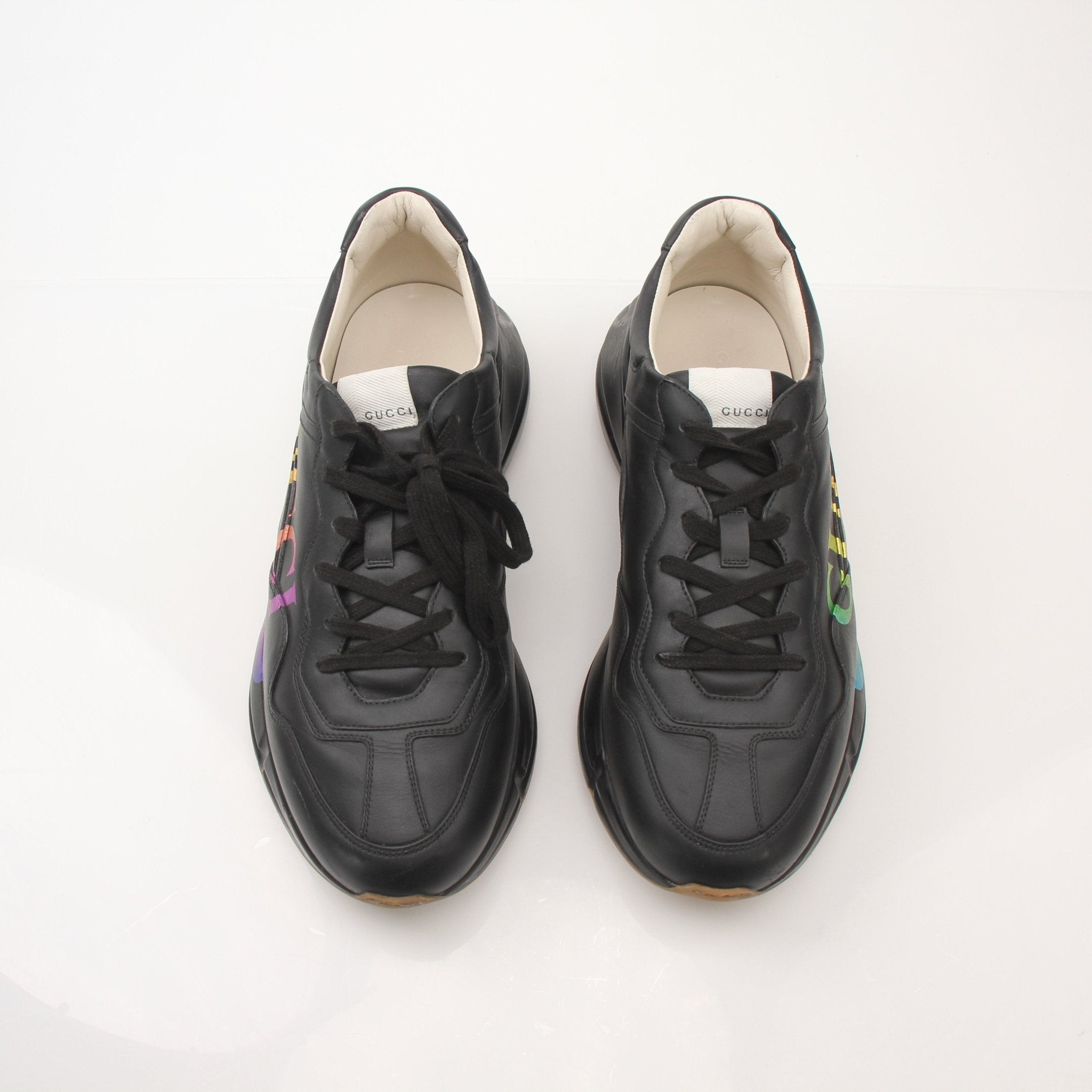 Gucci men's Rython iridescent logo sneakers, stylish shoes with shiny, colorful finish and iconic branding, on a plain background.