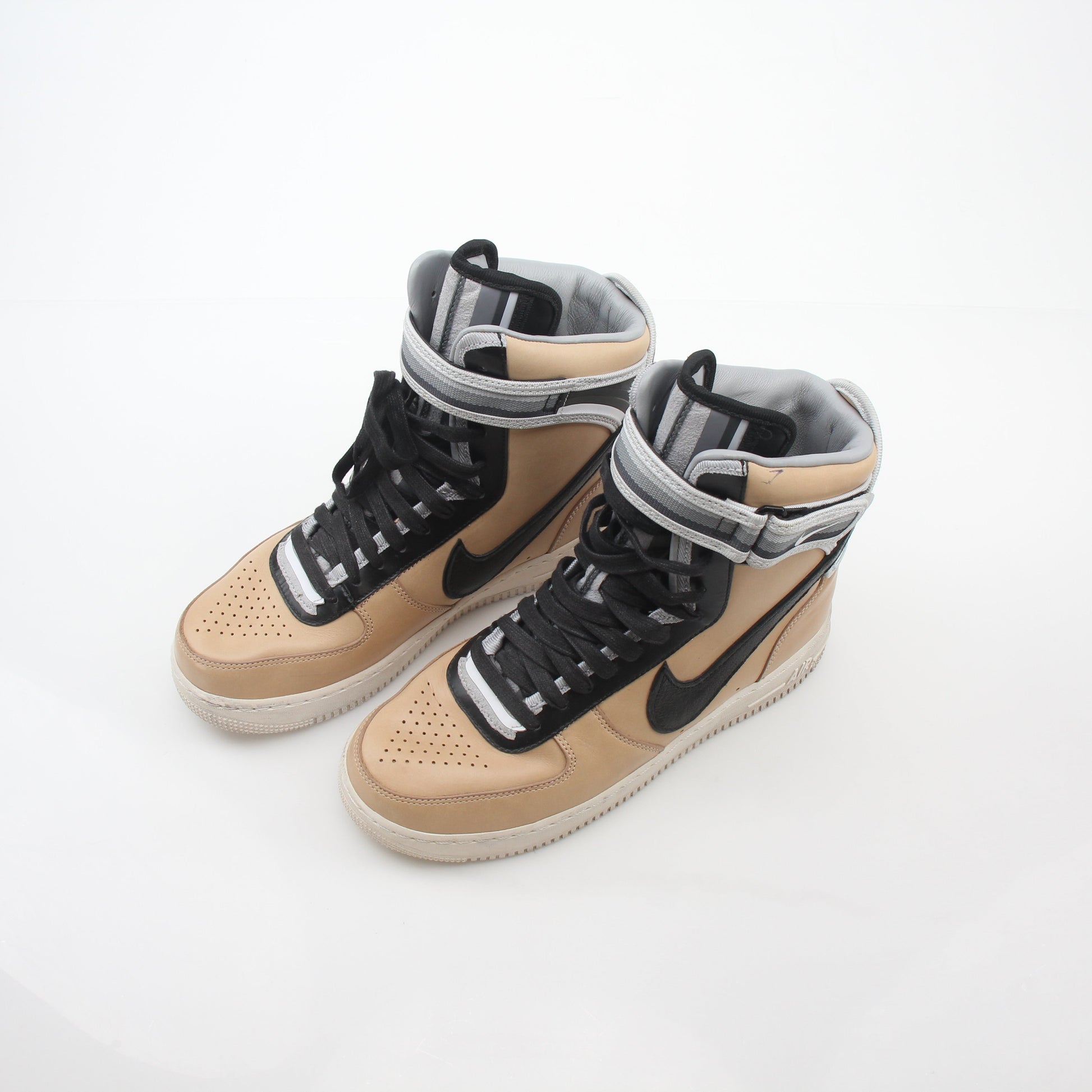 Nike x Riccardo Tisci Tan Air Force 1 High SP sneakers with gold accents and high-top design, displayed on a clean background.