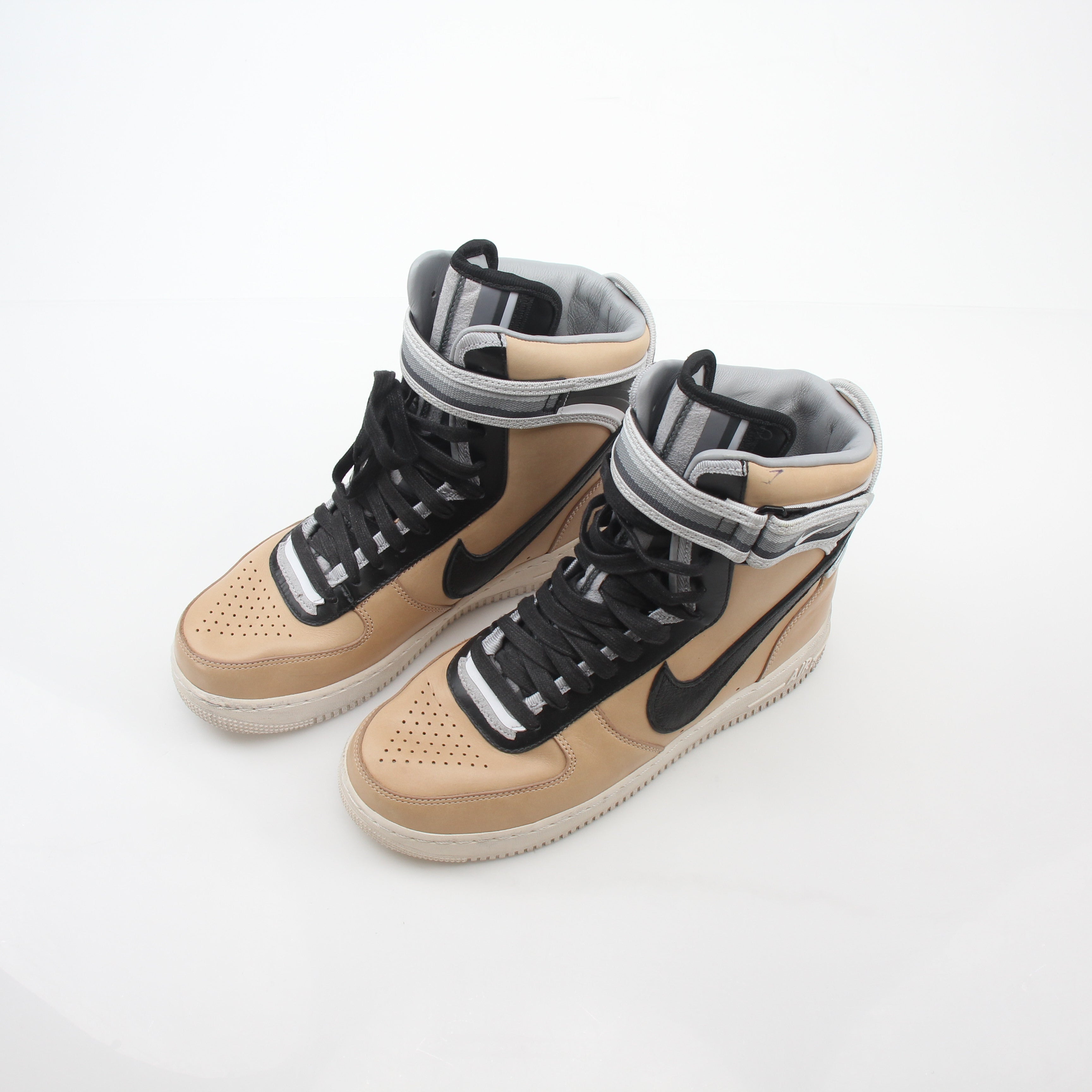 Nike x Riccardo Tisci Tan Air Force 1 High SP sneakers with gold accents and high-top design, displayed on a clean background.