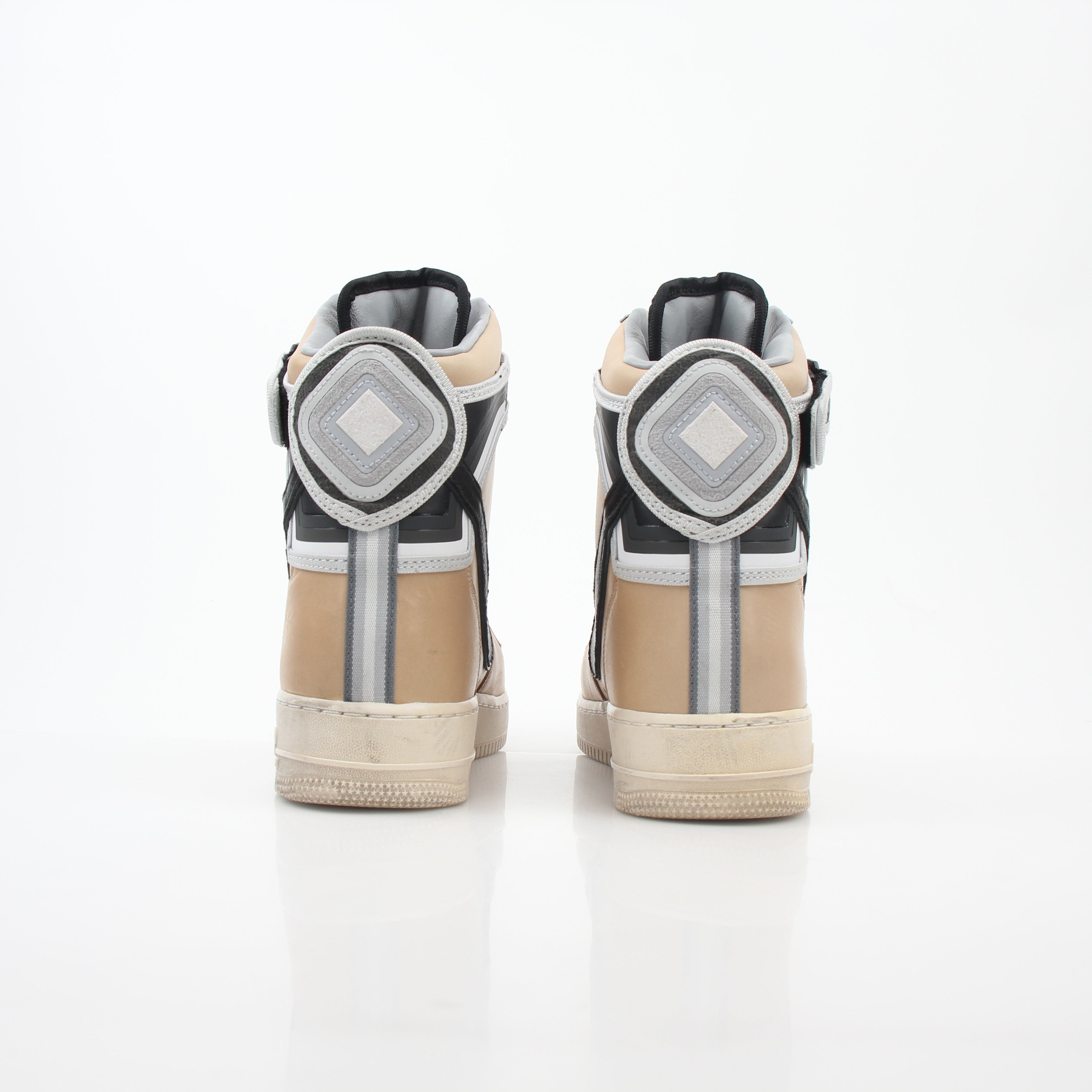 Nike x Riccardo Tisci Tan Air Force 1 High SP sneakers, gold and beige shoes with Nike branding and high-top design.