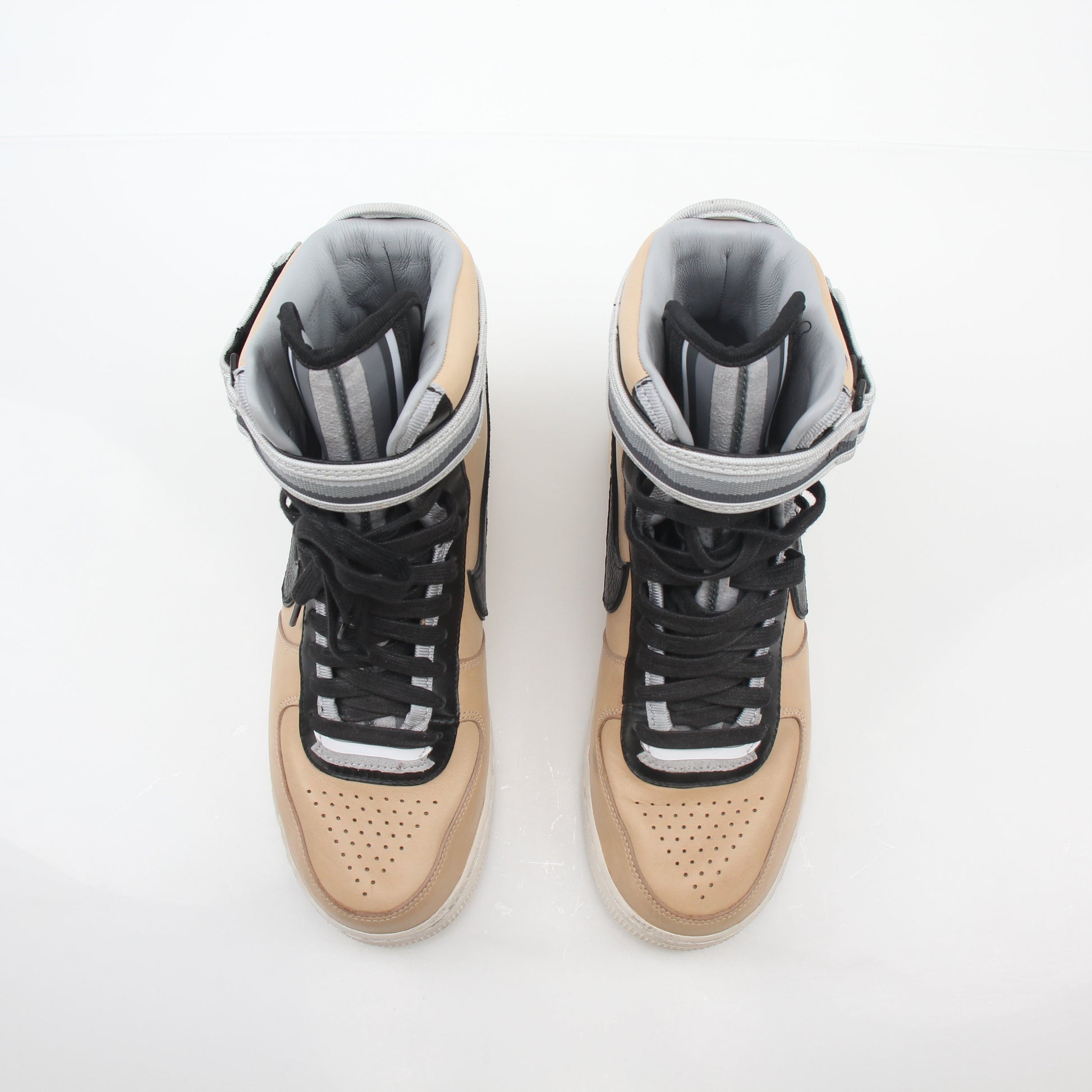 Nike x Riccardo Tisci Tan Air Force 1 High SP sneakers in gold and beige with high-top design and signature branding.