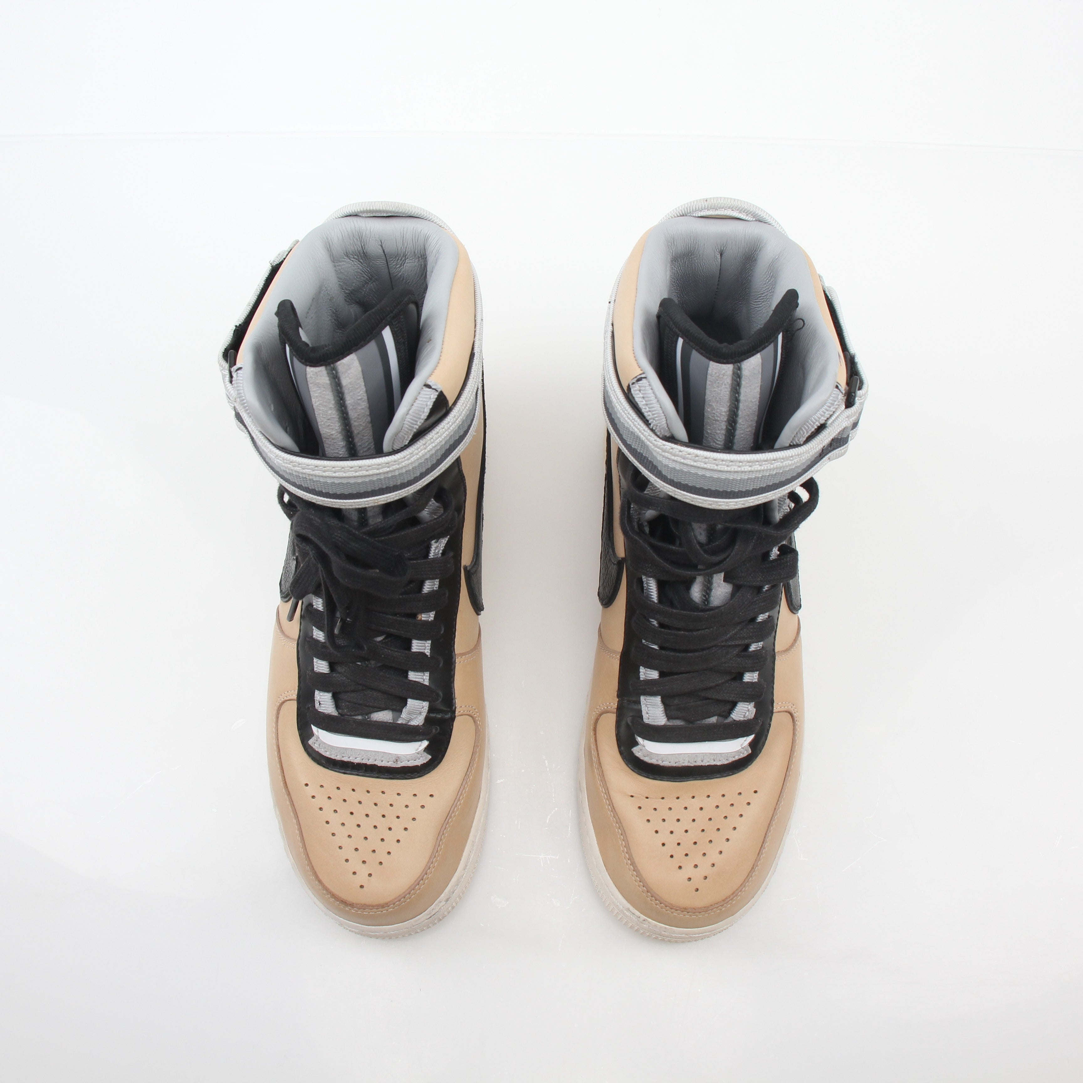 Nike x Riccardo Tisci Tan Air Force 1 High SP sneakers in gold and beige with high-top design and signature branding.