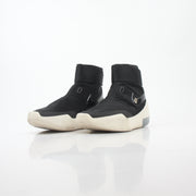 Black Nike x Fear of God Air Fear of God 1 high-top sneakers, showing sleek design and Nike branding on the shoes.