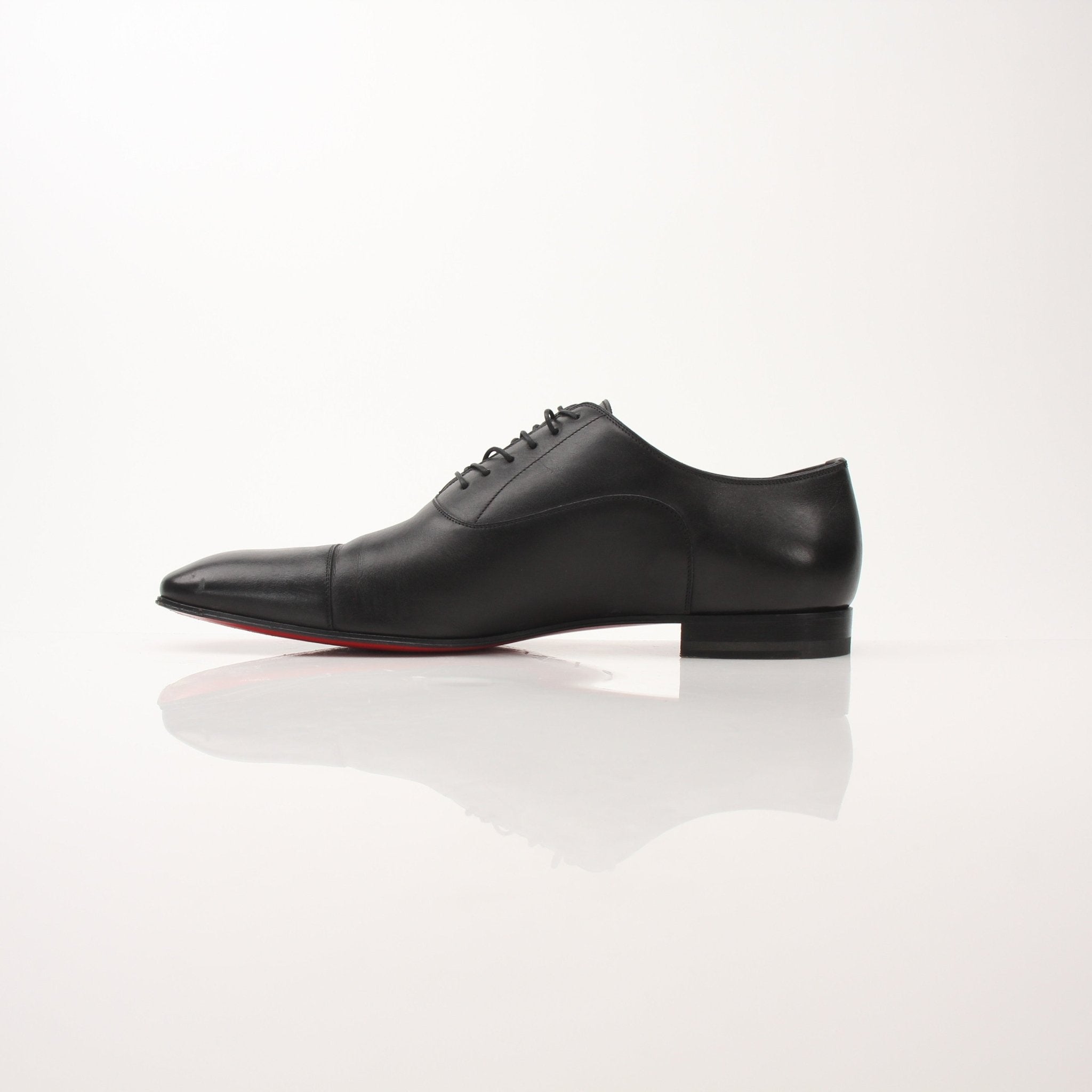 Christian Louboutin Greggo men's oxford shoes in black leather with red soles, stylish formal footwear from Gold & Beyond.