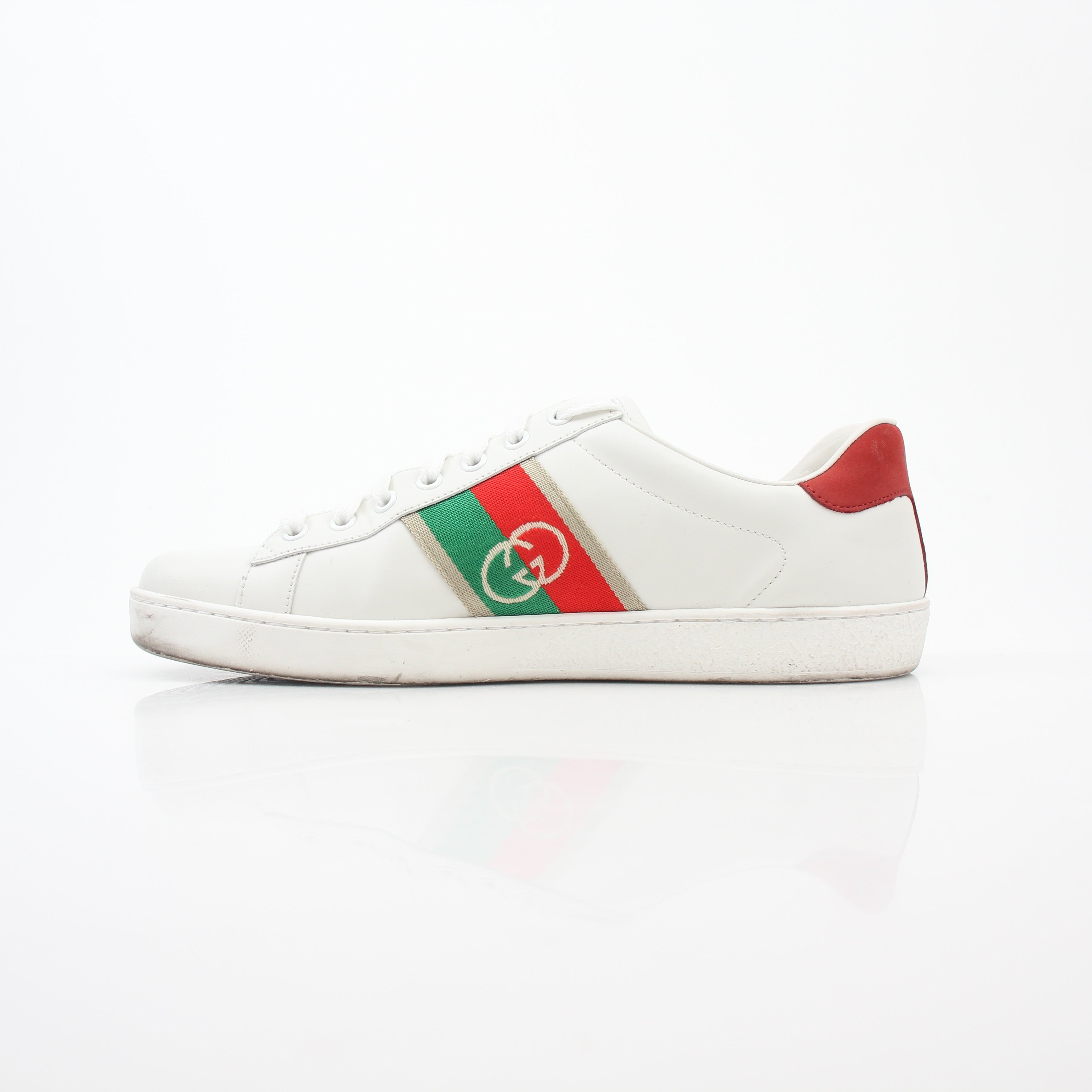 White Gucci Ace interlocking G web leather sneakers, stylish shoes with classic branding and sleek design.