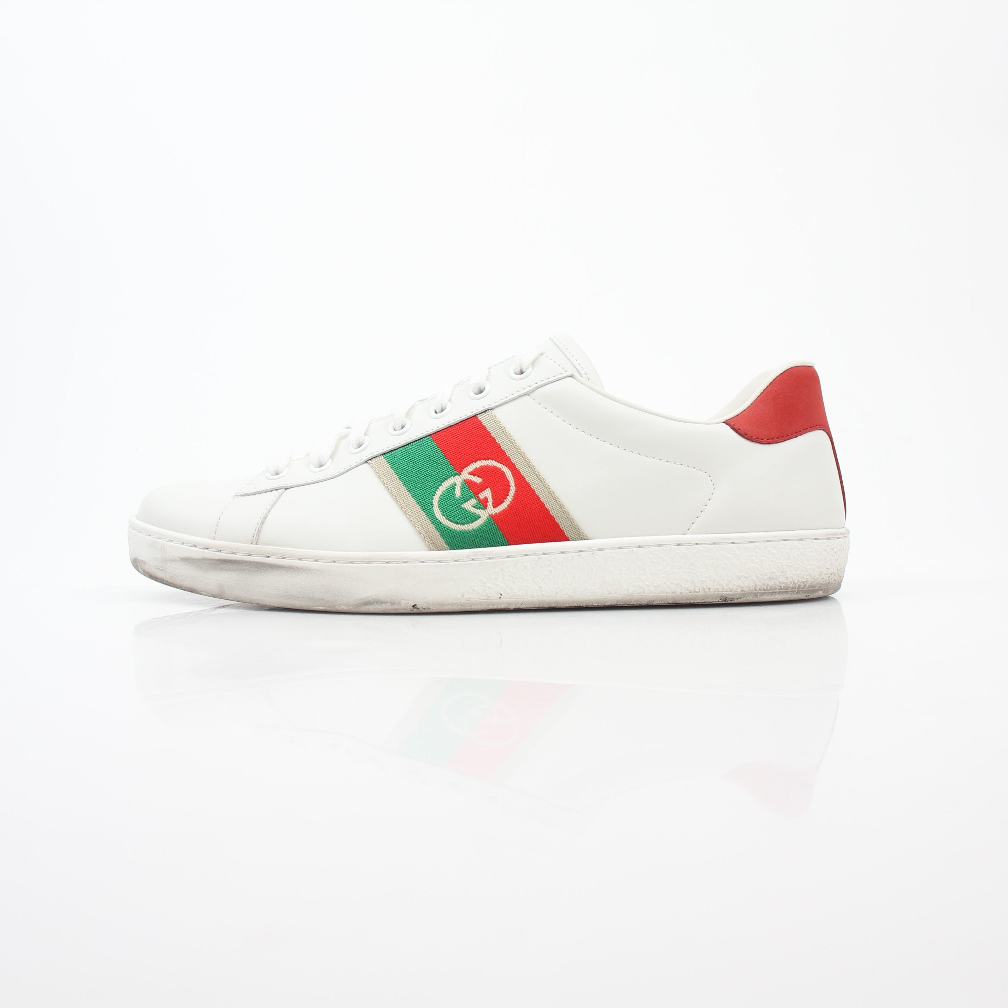 Gucci White Ace sneakers with interlocking G web leather design, casual footwear with sleek style and signature branding.