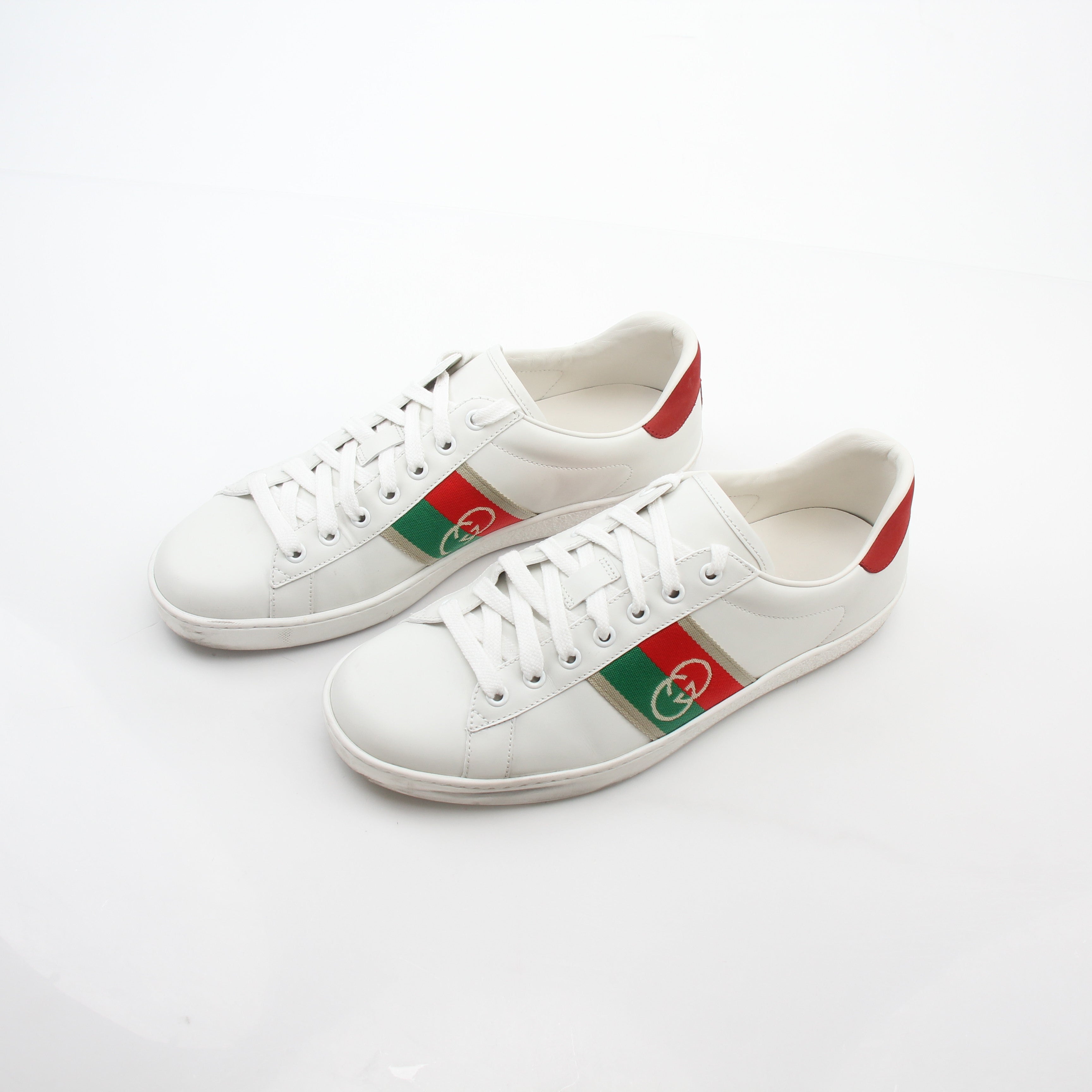 Gucci White Ace Interlocking G Web Leather Sneakers with gold accents, showcasing the stylish design and brand logo.