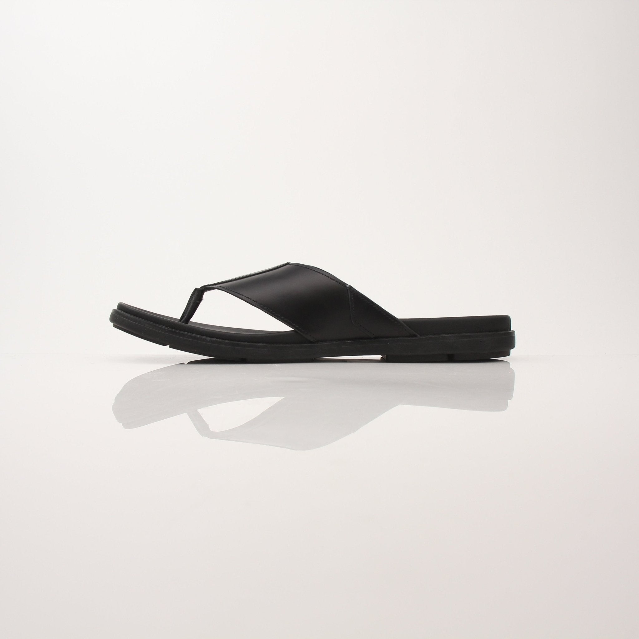 Gold & Beyond Prada men's logo thong sandals with black straps and Prada branding on the footbed, casual and stylish footwear.