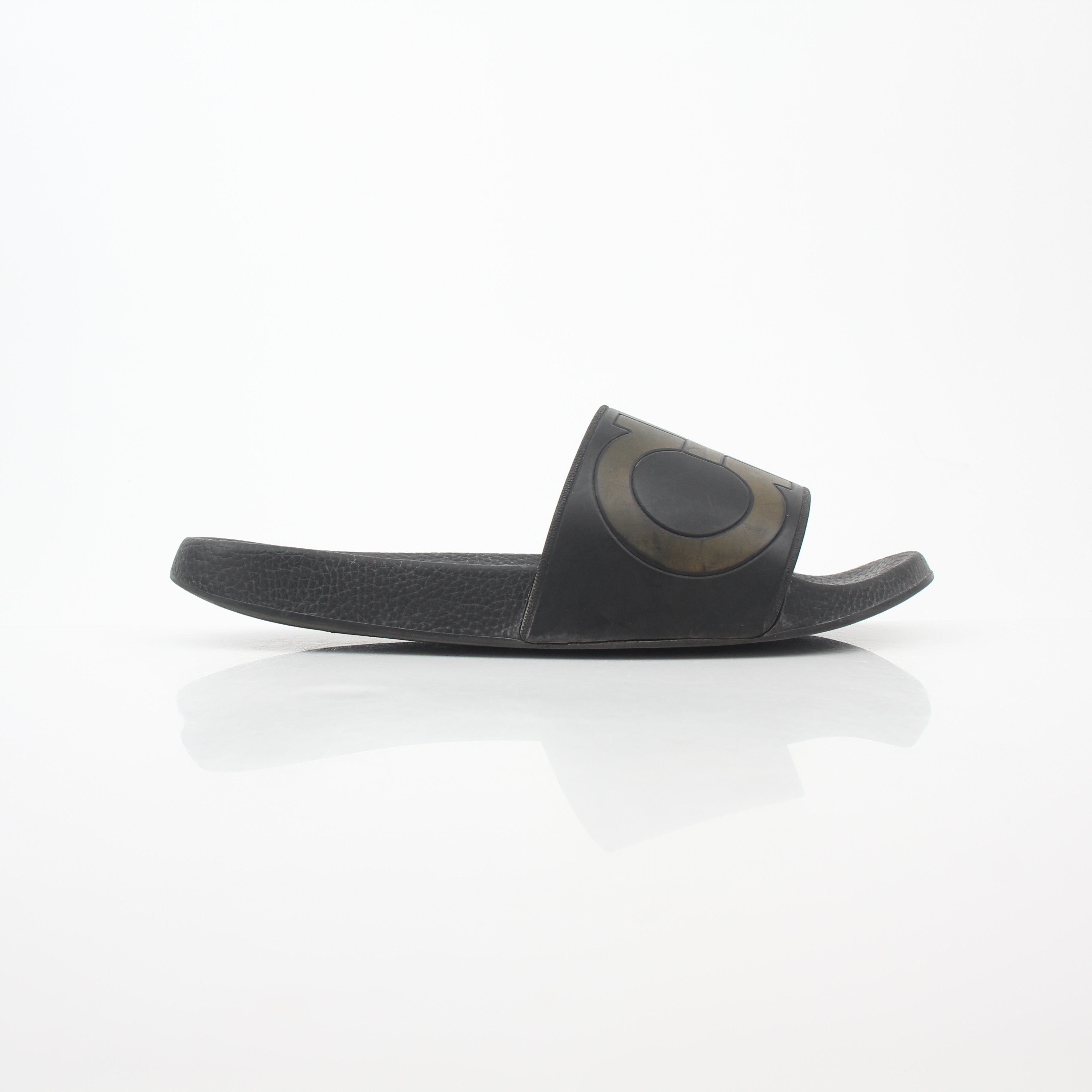 Black Salvatore Ferragamo Groove 2 Gancini slide sandals with leather straps and Gancini hardware, displayed on a neutral background.