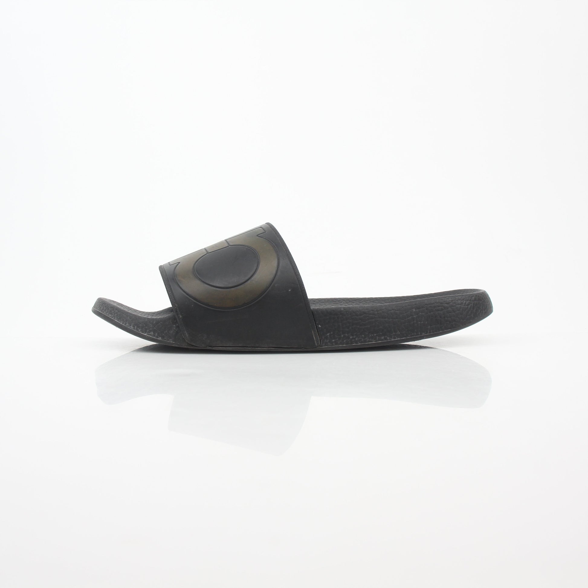 Black Salvatore Ferragamo Groove 2 Gancini slide sandals with leather straps and signature Gancini hardware, laid flat on a neutral background.