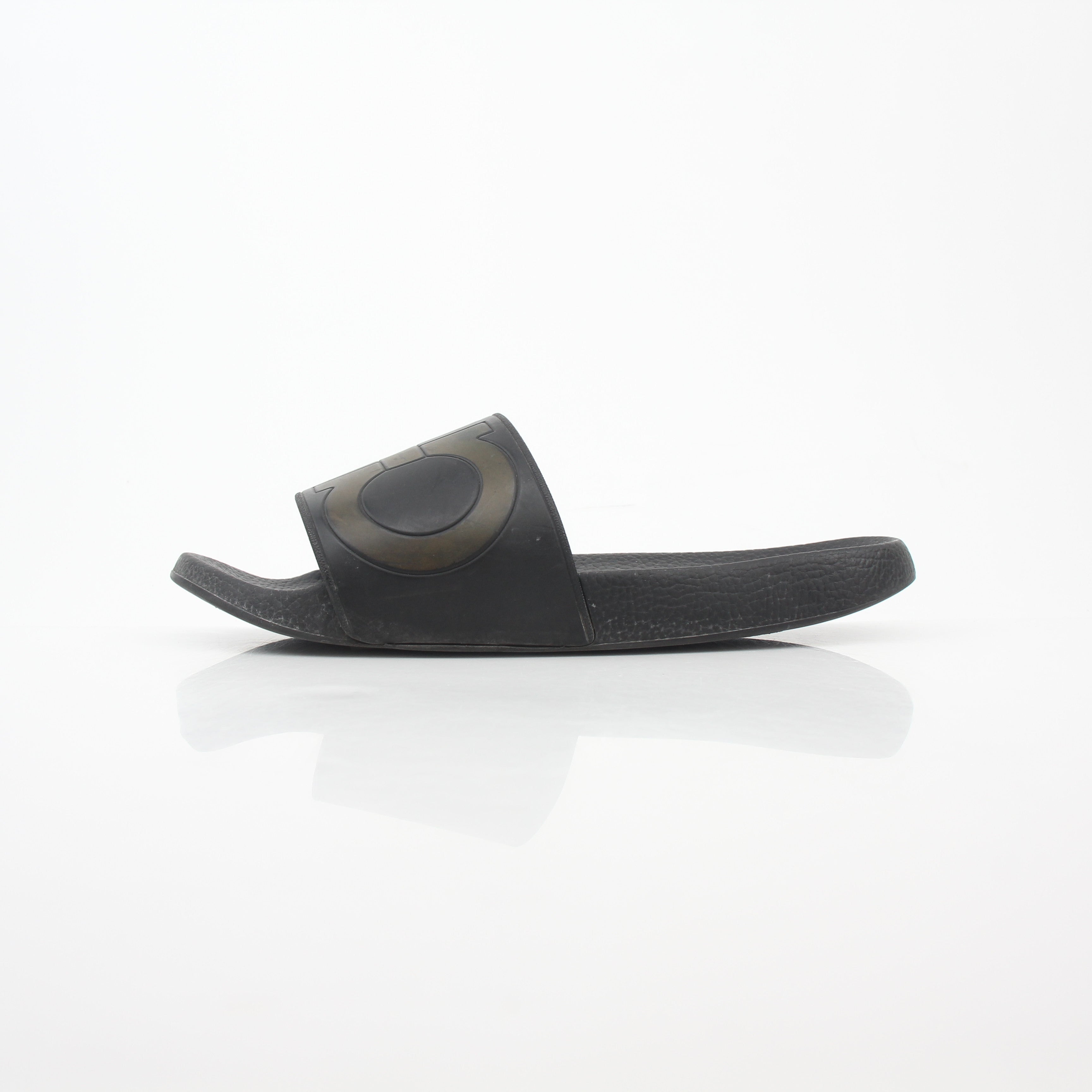 Black Salvatore Ferragamo Groove 2 Gancini slide sandals with leather straps and signature Gancini hardware, laid flat on a neutral background.