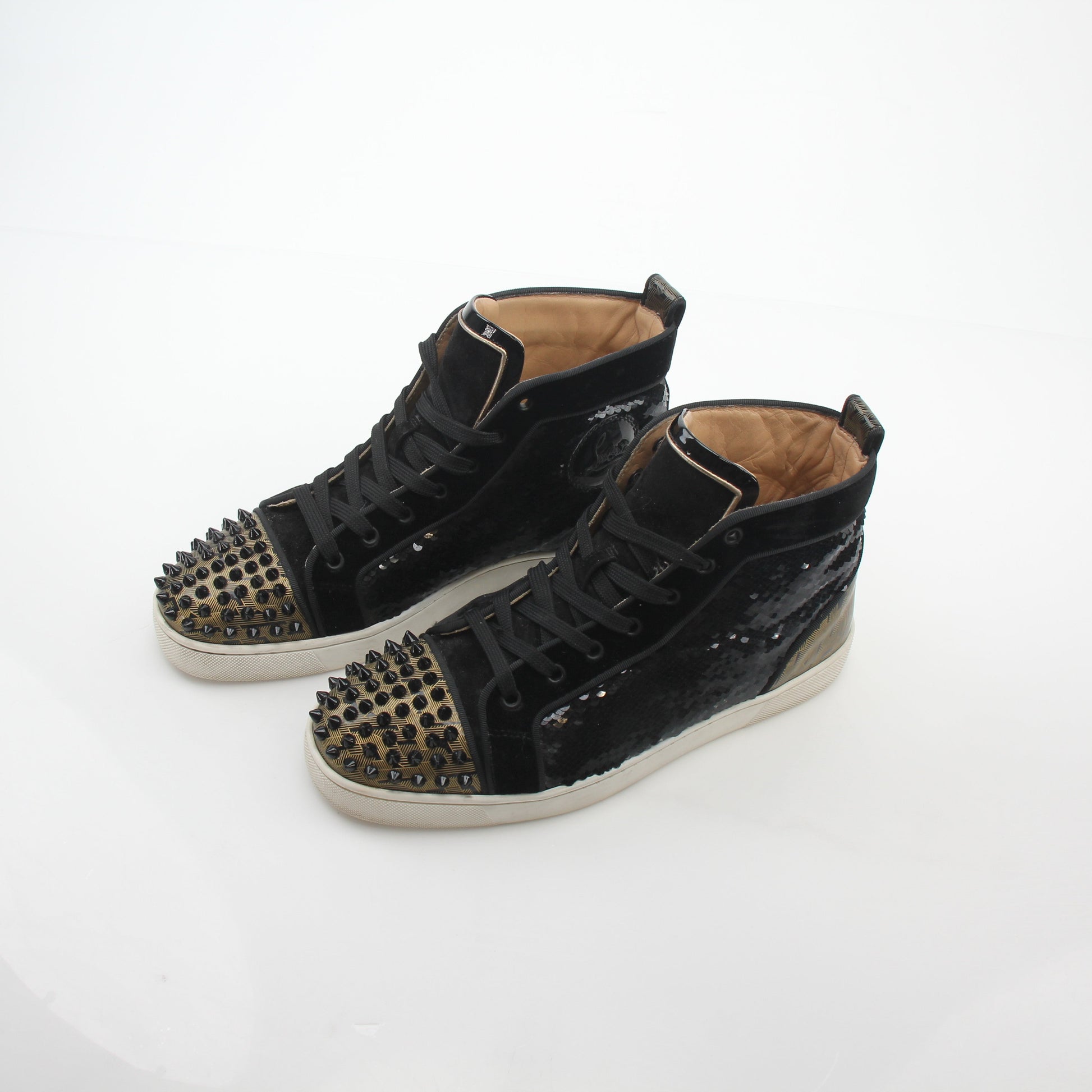 Black Christian Louboutin Lou Spikes Orlato high-top sneakers with spikes and edgy design, by Gold & Beyond.
